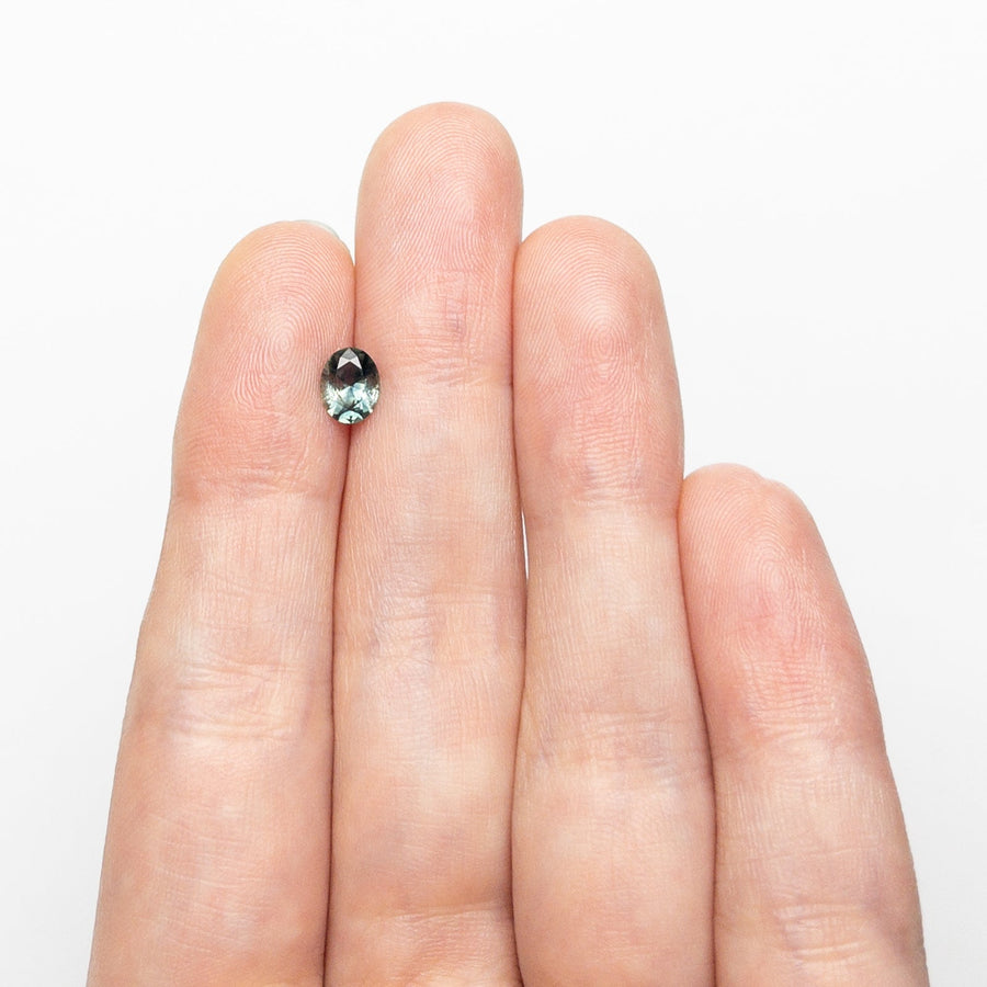 The 0.66ct 6.08x4.80x2.94mm Oval Brilliant Sapphire 26668-04 by East London jeweller Rachel Boston | Discover our collections of unique and timeless engagement rings, wedding rings, and modern fine jewellery. - Rachel Boston Jewellery