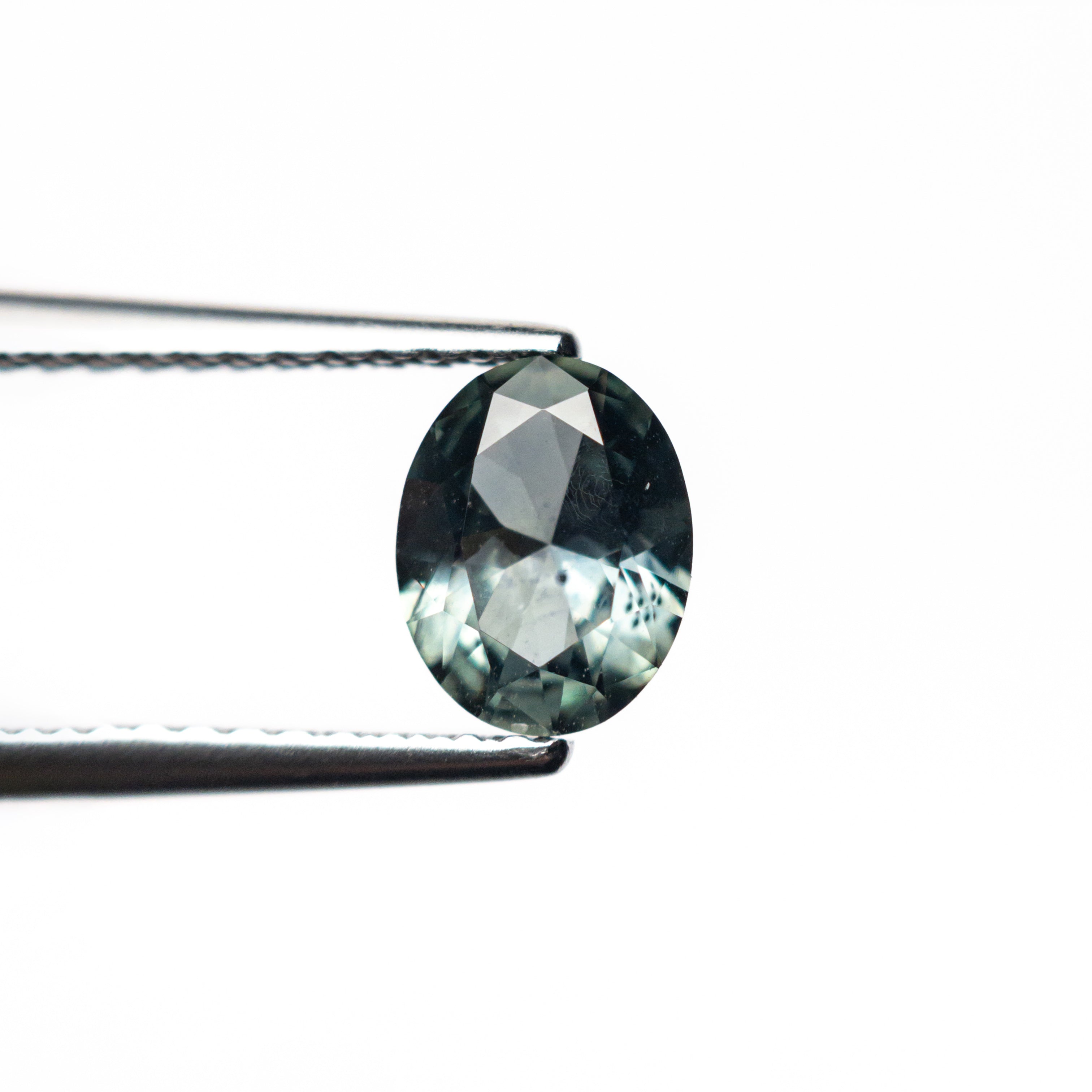The 0.80ct 6.53x5.11x2.99mm Oval Brilliant Sapphire 26668-23 by East London jeweller Rachel Boston | Discover our collections of unique and timeless engagement rings, wedding rings, and modern fine jewellery.