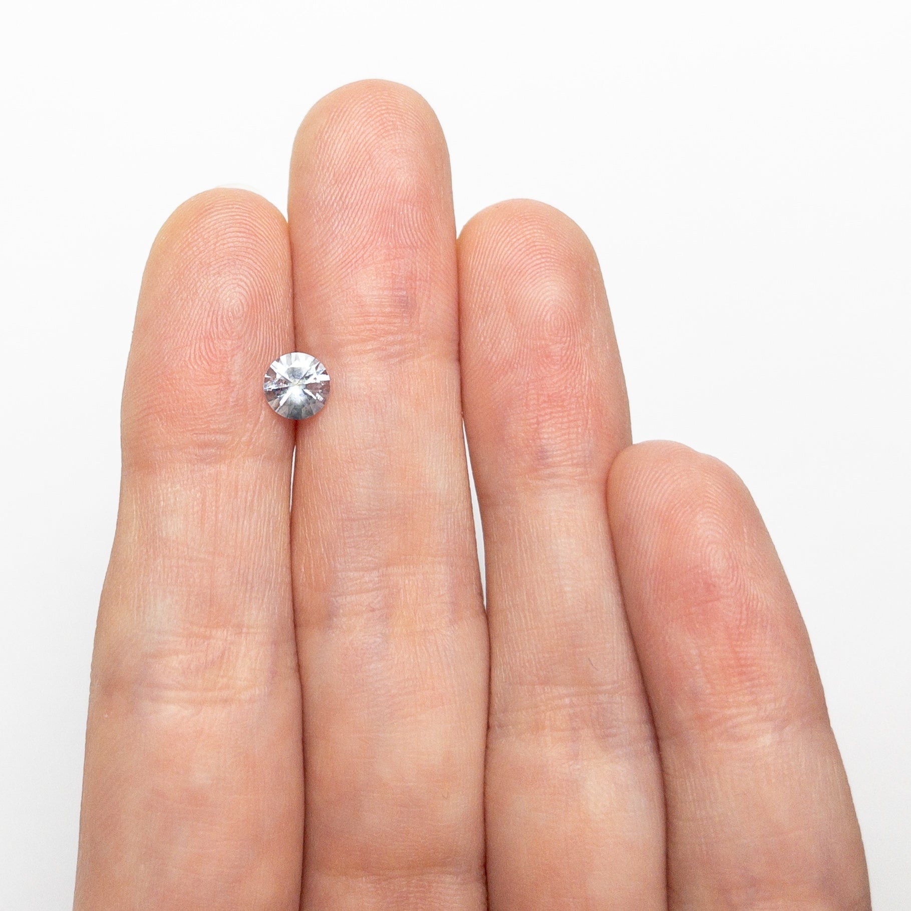 The 0.69ct 5.33x5.31x3.40mm Round Brilliant Sapphire 26766-12 by East London jeweller Rachel Boston | Discover our collections of unique and timeless engagement rings, wedding rings, and modern fine jewellery.