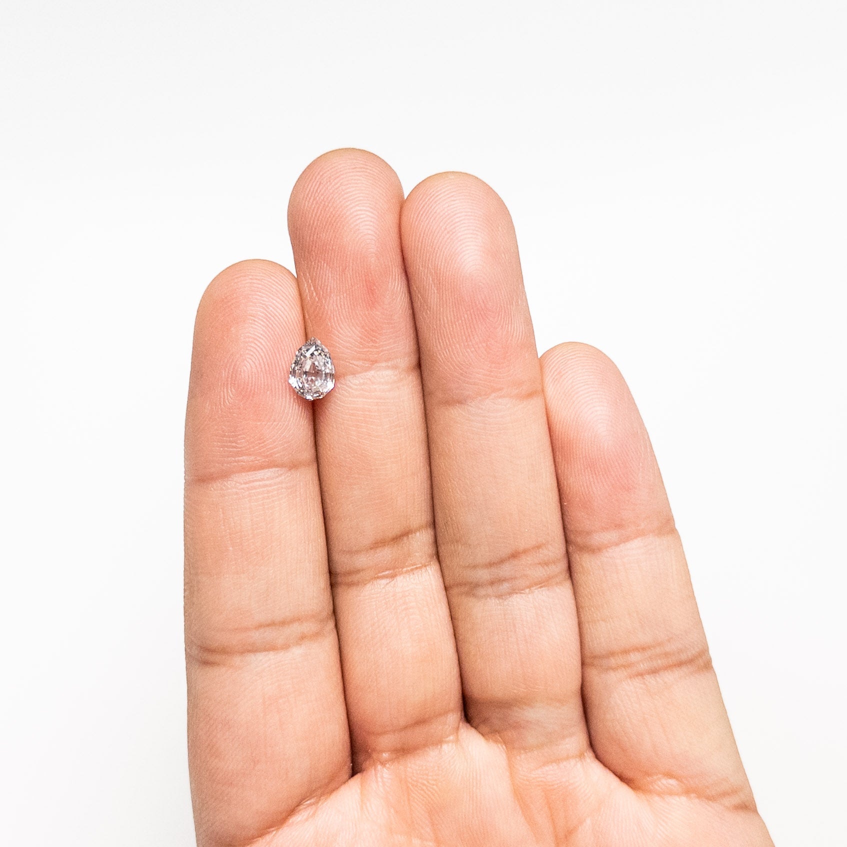 The 1.10ct 7.91x5.51x3.39mm Geo Pear Step Cut 🇨🇦 26879-01 by East London jeweller Rachel Boston | Discover our collections of unique and timeless engagement rings, wedding rings, and modern fine jewellery.