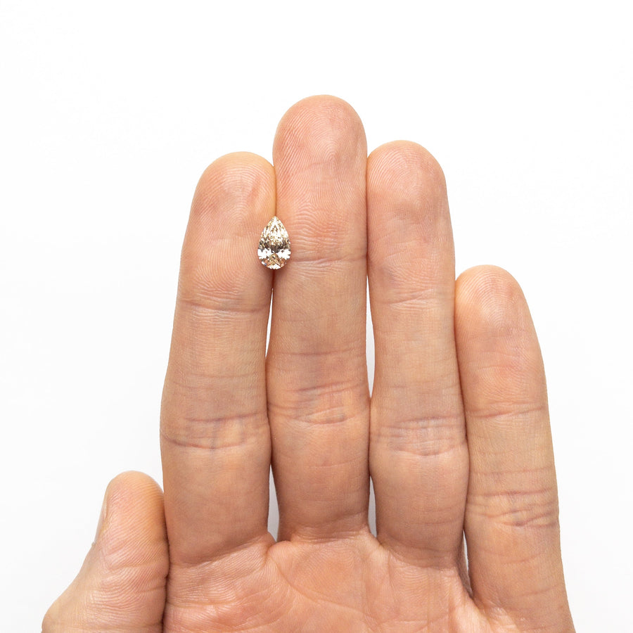 The 1.00ct 8.95x5.53x3.40mm VS2 Q-R Pear Brilliant 27081-05 by East London jeweller Rachel Boston | Discover our collections of unique and timeless engagement rings, wedding rings, and modern fine jewellery. - Rachel Boston Jewellery