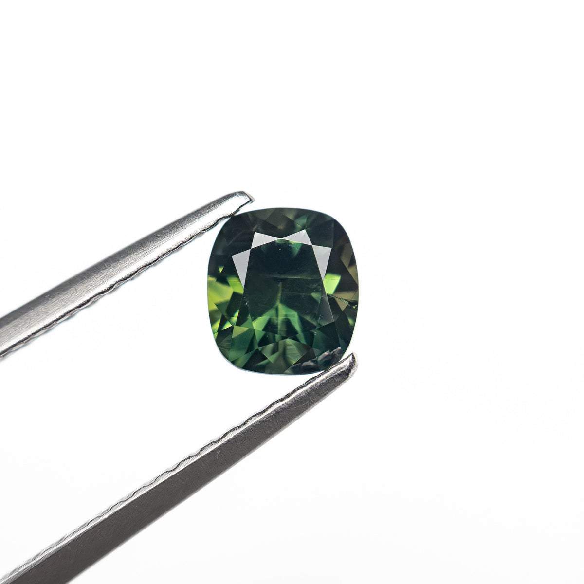 The 0.83ct 5.59x4.48x3.74mm Cushion Brilliant Sapphire 27336-09 by East London jeweller Rachel Boston | Discover our collections of unique and timeless engagement rings, wedding rings, and modern fine jewellery.