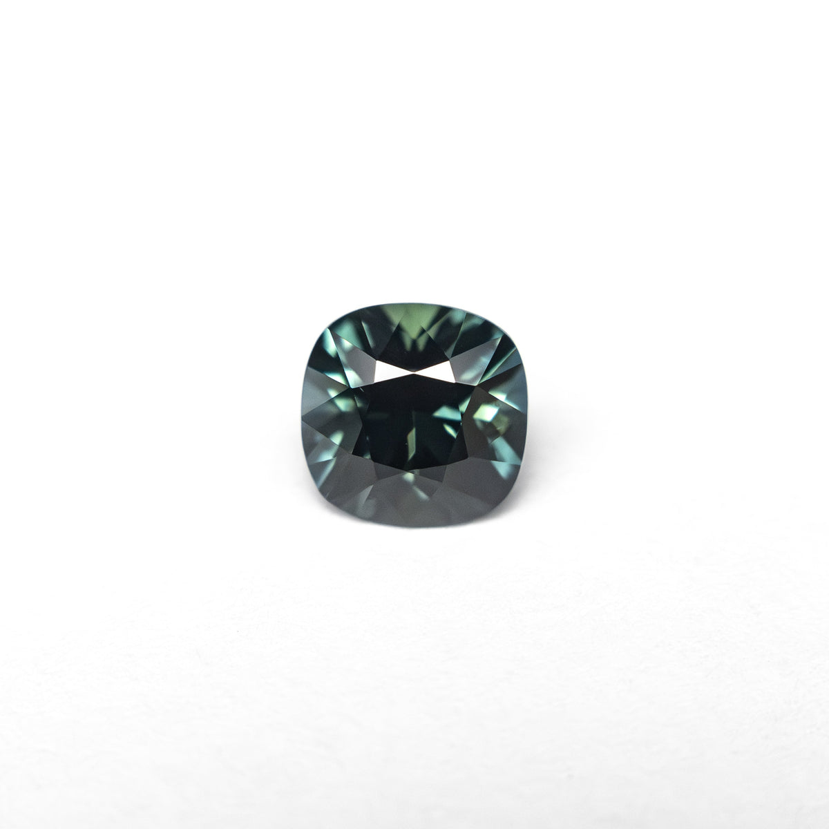 The 0.63ct 4.92x4.91x3.52mm Cushion Brilliant Sapphire 27336-13 by East London jeweller Rachel Boston | Discover our collections of unique and timeless engagement rings, wedding rings, and modern fine jewellery.