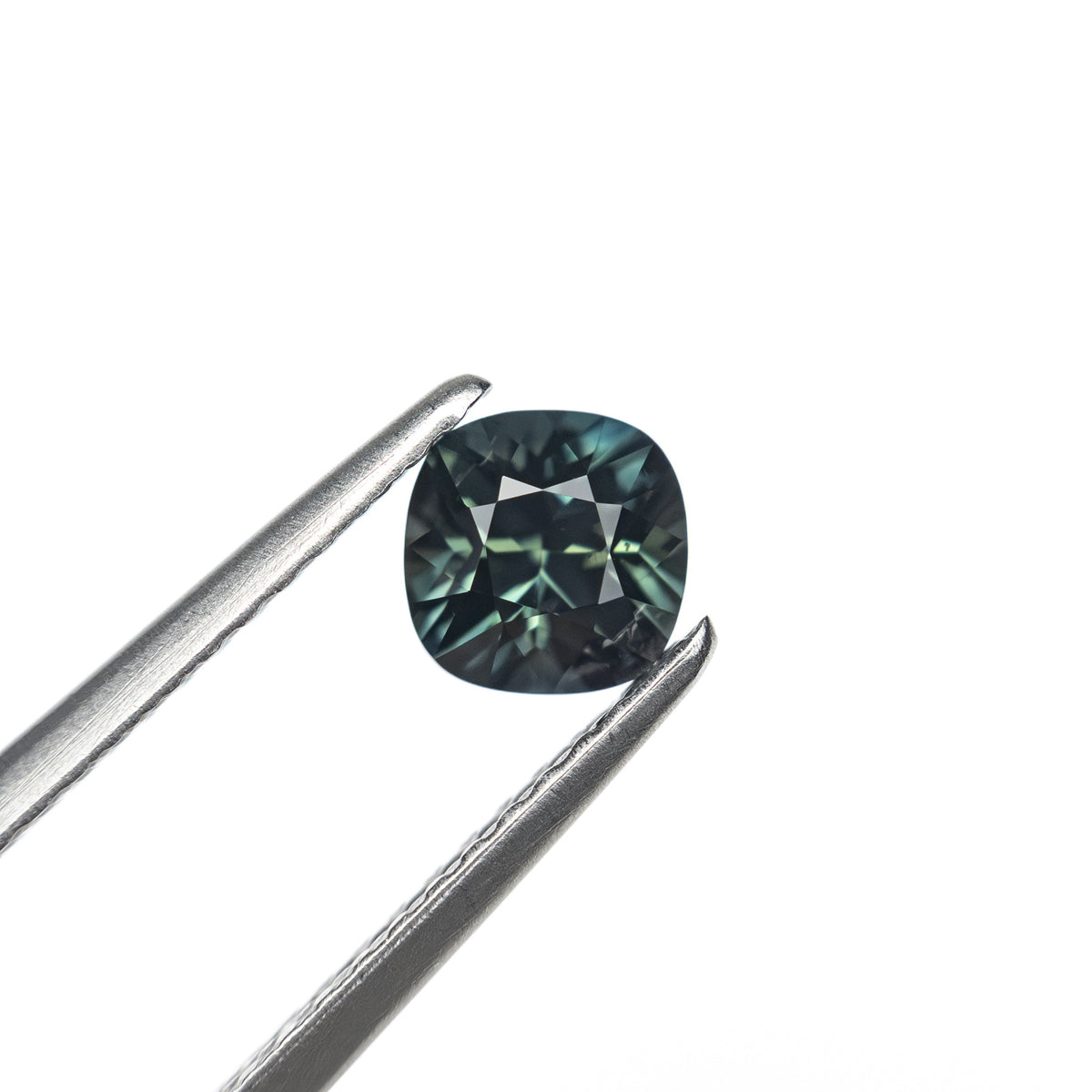 The 0.63ct 4.92x4.91x3.52mm Cushion Brilliant Sapphire 27336-13 by East London jeweller Rachel Boston | Discover our collections of unique and timeless engagement rings, wedding rings, and modern fine jewellery.
