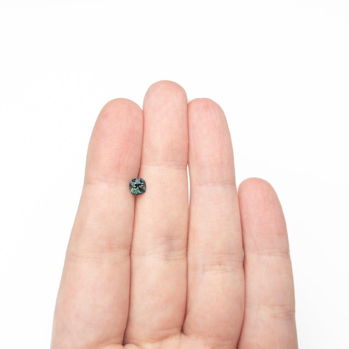 The 0.63ct 4.92x4.91x3.52mm Cushion Brilliant Sapphire 27336-13 by East London jeweller Rachel Boston | Discover our collections of unique and timeless engagement rings, wedding rings, and modern fine jewellery.