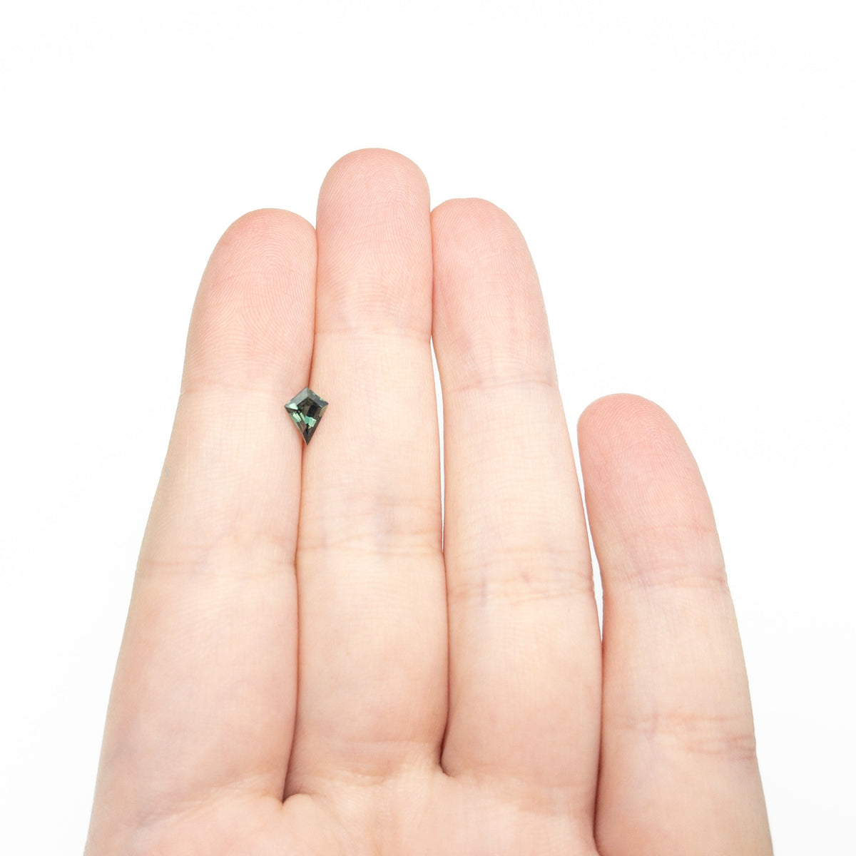 The 0.60ct 7.22x4.75x3.22mm Kite Step Cut Sapphire 27336-19 by East London jeweller Rachel Boston | Discover our collections of unique and timeless engagement rings, wedding rings, and modern fine jewellery.