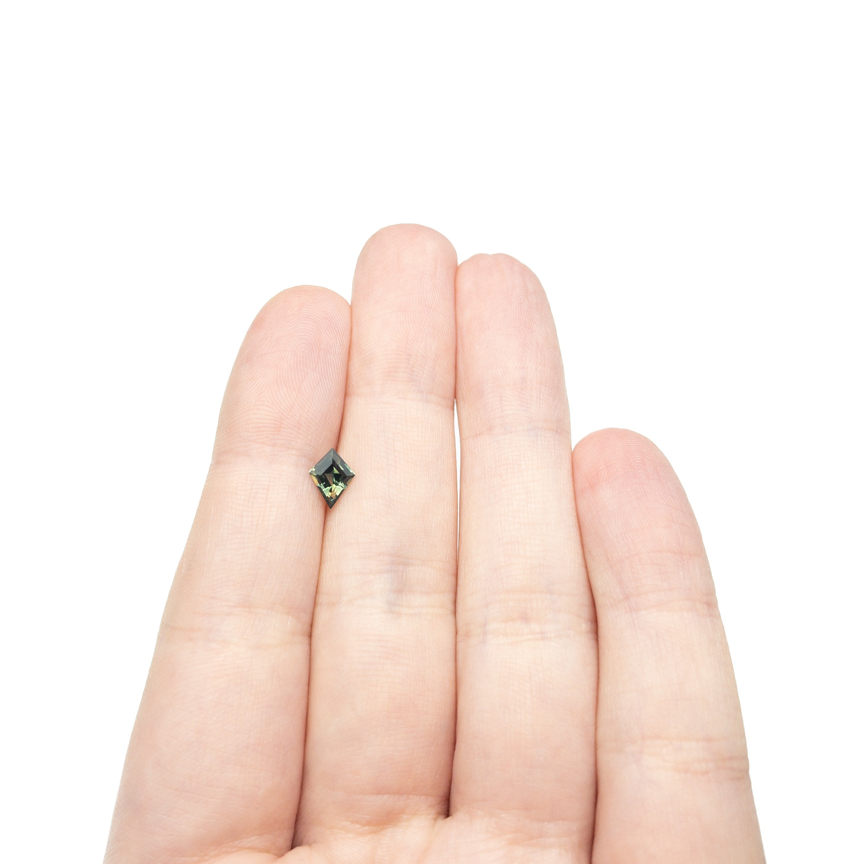 The 0.66ct 7.66x4.86x3.08mm Kite Step Cut Sapphire 27336-24 by East London jeweller Rachel Boston | Discover our collections of unique and timeless engagement rings, wedding rings, and modern fine jewellery.