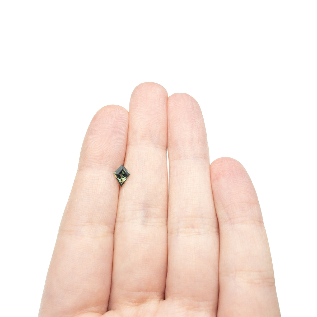 The 0.66ct 7.66x4.86x3.08mm Kite Step Cut Sapphire 27336-24 by East London jeweller Rachel Boston | Discover our collections of unique and timeless engagement rings, wedding rings, and modern fine jewellery.