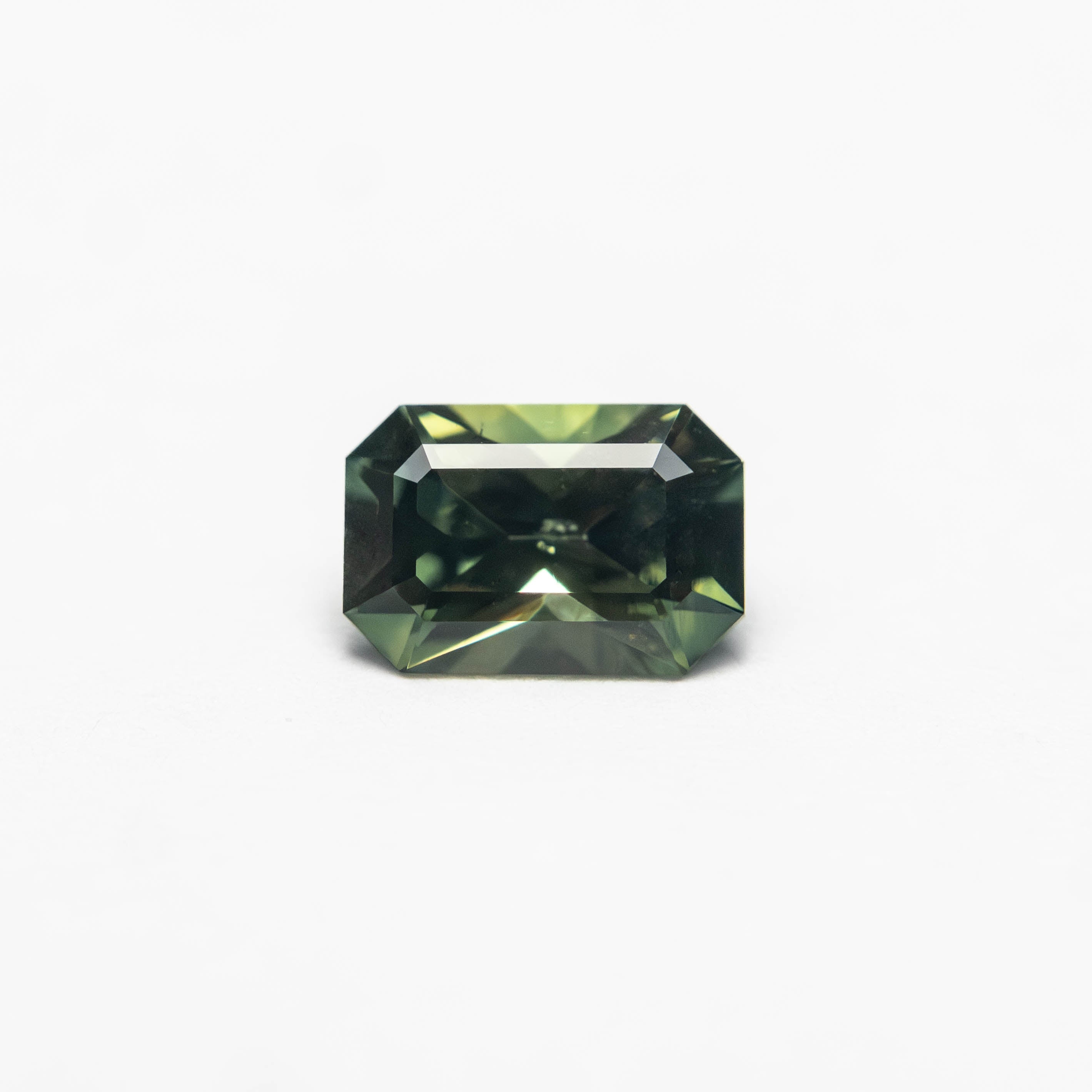 The 0.52ct 5.68x3.86x2.78mm Cut Corner Rectangle Step Cut Sapphire 27336-31 by East London jeweller Rachel Boston | Discover our collections of unique and timeless engagement rings, wedding rings, and modern fine jewellery.