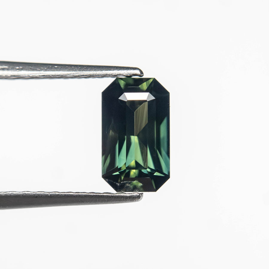 The 0.77ct 6.89x4.13x2.91mm Cut Corner Rectangle Step Cut Sapphire 27336-36 by East London jeweller Rachel Boston | Discover our collections of unique and timeless engagement rings, wedding rings, and modern fine jewellery. - Rachel Boston Jewellery