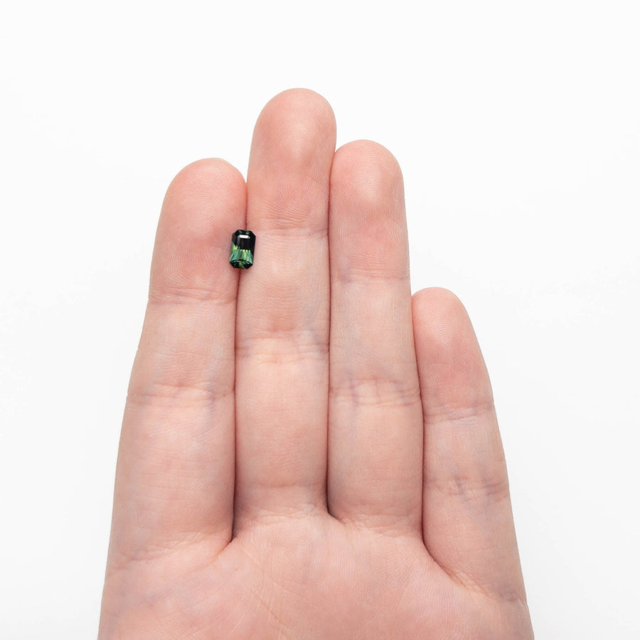 The 0.77ct 6.89x4.13x2.91mm Cut Corner Rectangle Step Cut Sapphire 27336-36 by East London jeweller Rachel Boston | Discover our collections of unique and timeless engagement rings, wedding rings, and modern fine jewellery. - Rachel Boston Jewellery