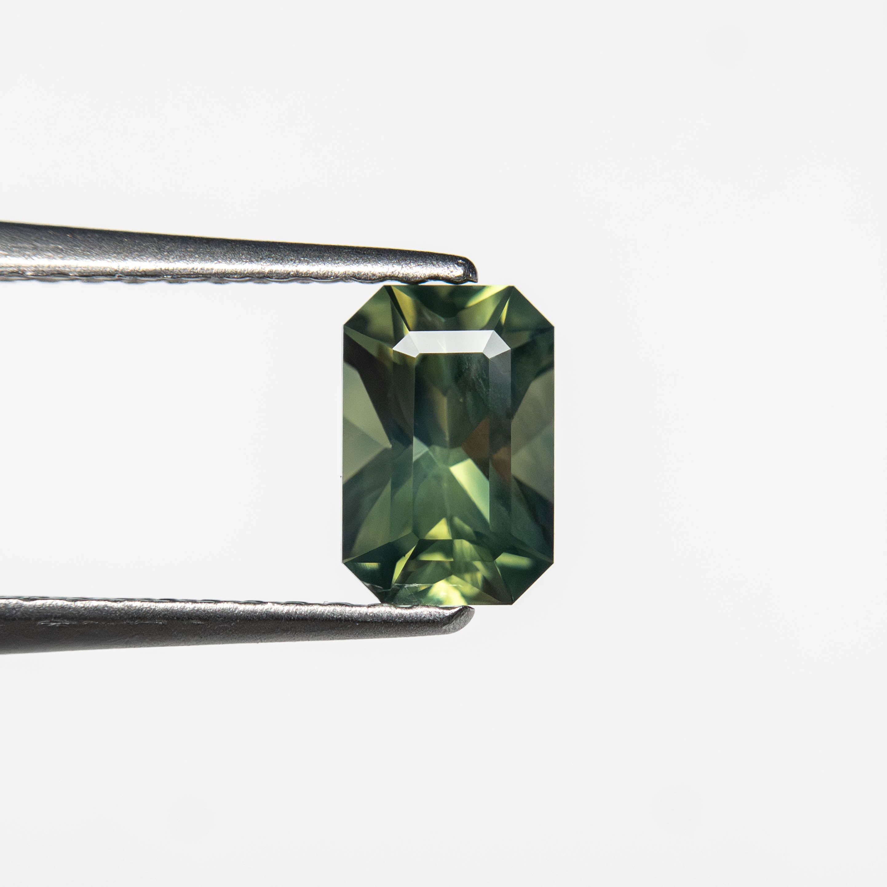 The 0.82ct 6.36x4.23x3.53mm Cut Corner Rectangle Step Cut Sapphire 27336-37 by East London jeweller Rachel Boston | Discover our collections of unique and timeless engagement rings, wedding rings, and modern fine jewellery.