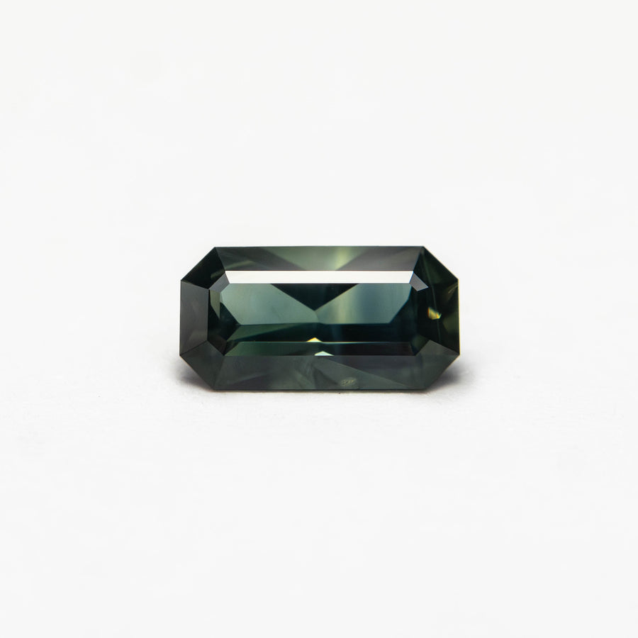 The 0.60ct 6.93x3.63x2.58mm Cut Corner Rectangle Step Cut Sapphire 27336-39 by East London jeweller Rachel Boston | Discover our collections of unique and timeless engagement rings, wedding rings, and modern fine jewellery. - Rachel Boston Jewellery