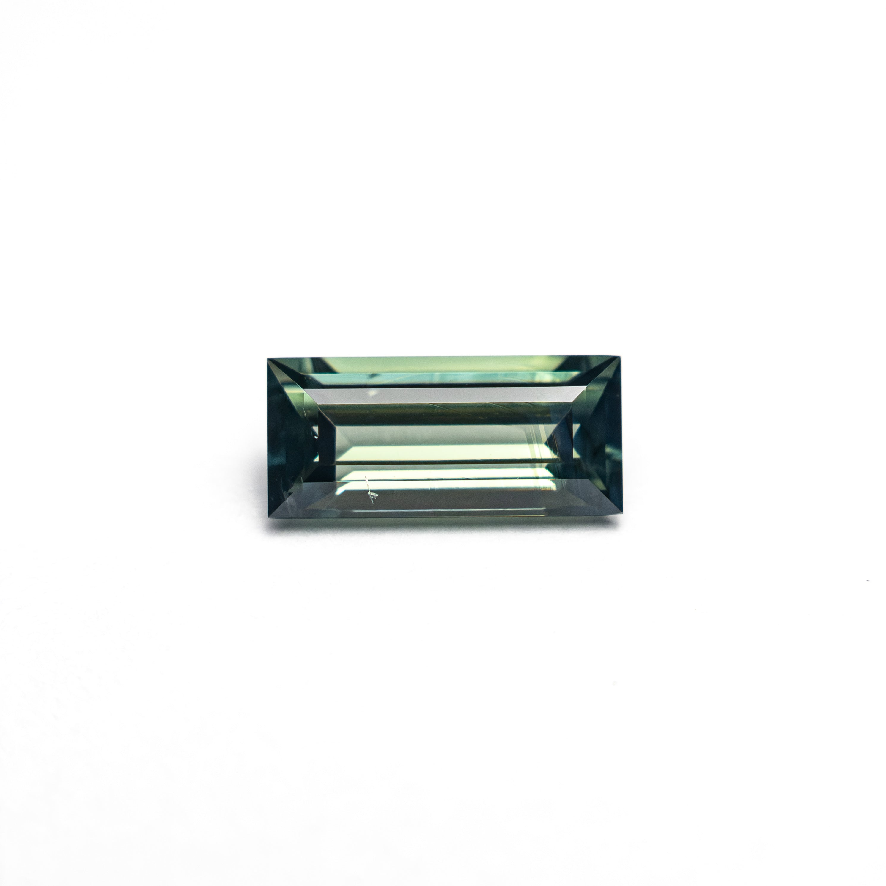 The 0.74ct 7.27x3.44x2.54mm Rectangle Step Cut Sapphire 27336-44 by East London jeweller Rachel Boston | Discover our collections of unique and timeless engagement rings, wedding rings, and modern fine jewellery.