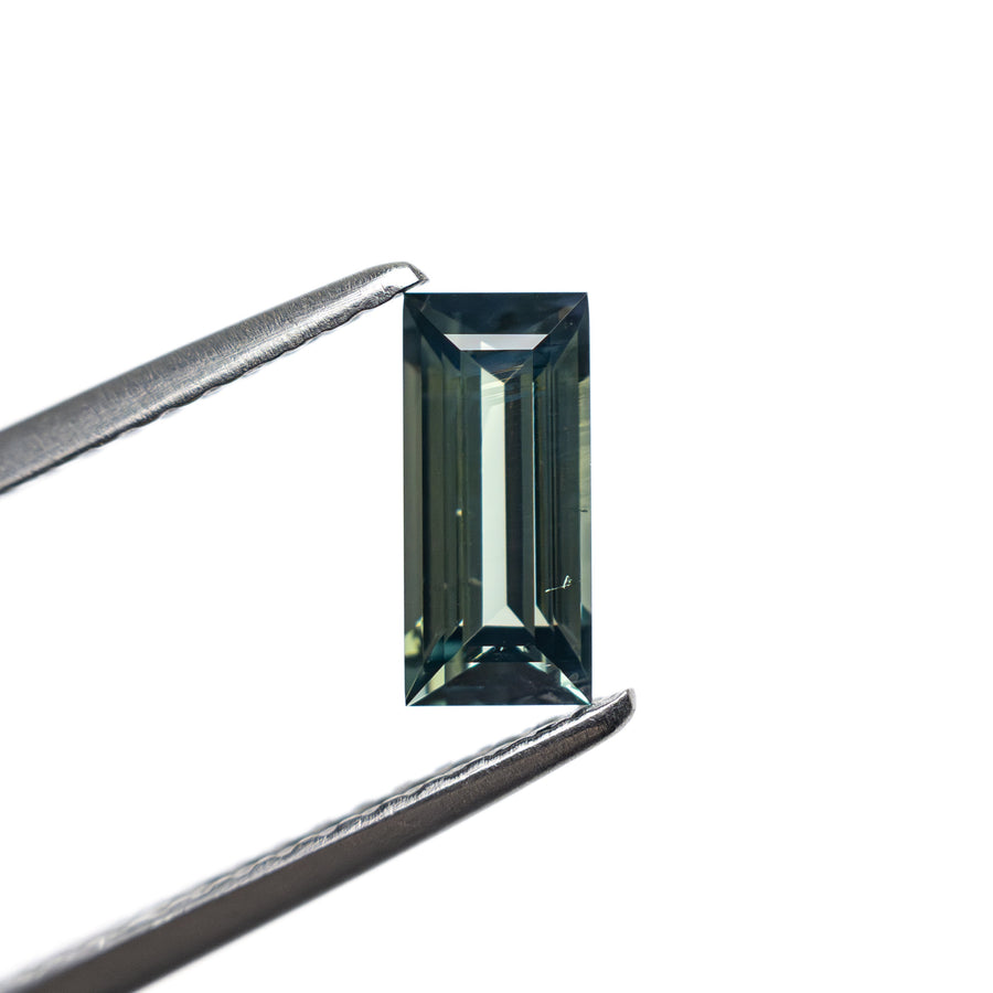 The 0.74ct 7.27x3.44x2.54mm Rectangle Step Cut Sapphire 27336-44 by East London jeweller Rachel Boston | Discover our collections of unique and timeless engagement rings, wedding rings, and modern fine jewellery. - Rachel Boston Jewellery