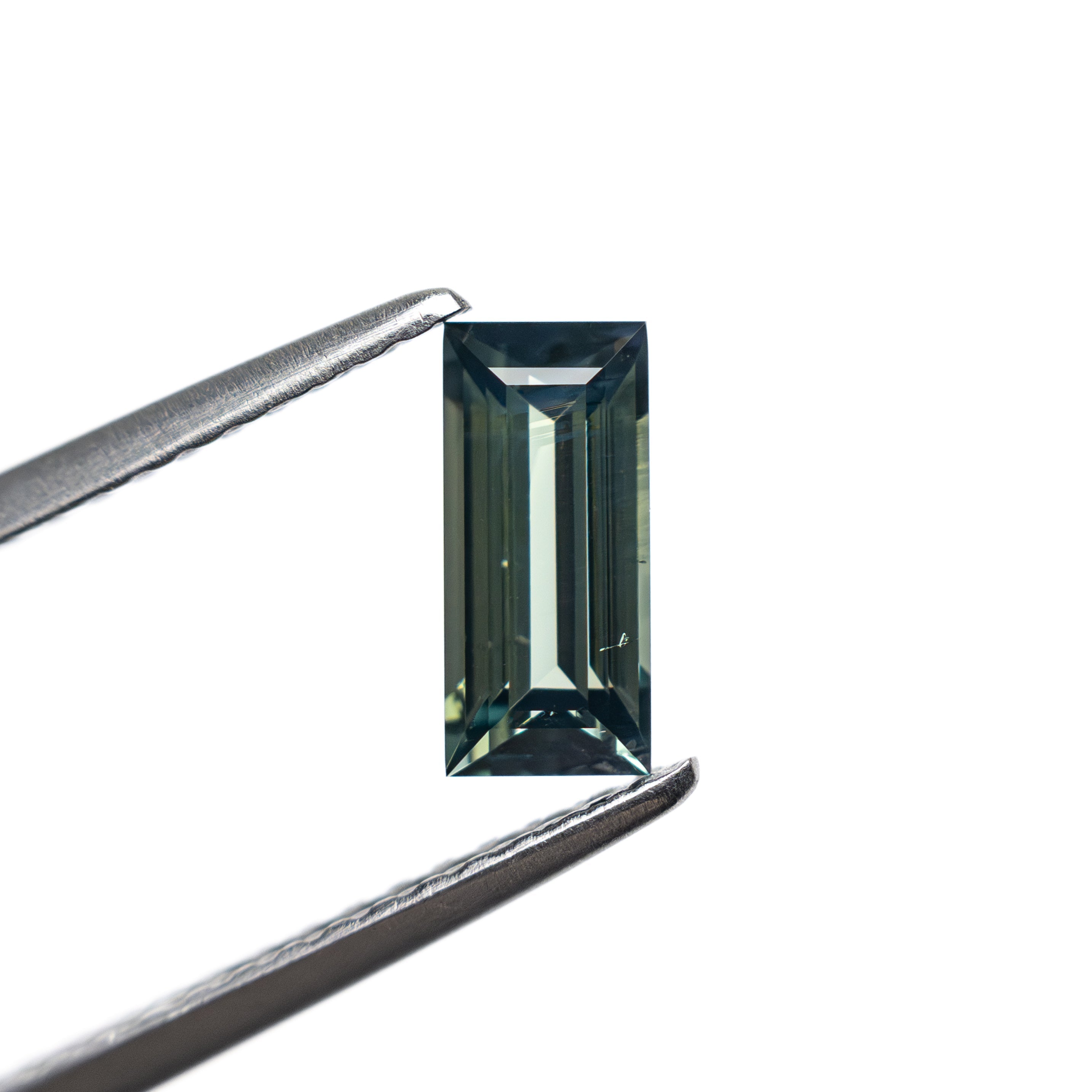 The 0.74ct 7.27x3.44x2.54mm Rectangle Step Cut Sapphire 27336-44 by East London jeweller Rachel Boston | Discover our collections of unique and timeless engagement rings, wedding rings, and modern fine jewellery.