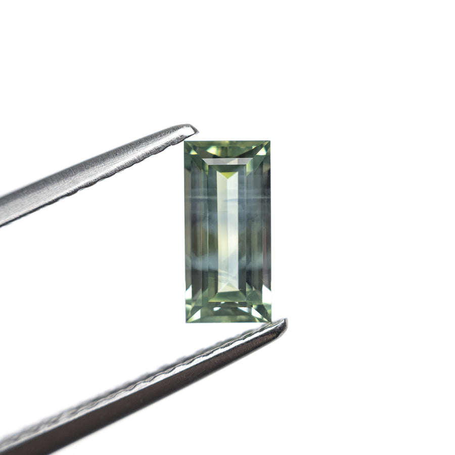 The 0.76ct 7.33x3.57x2.54mm Rectangle Step Cut Sapphire 27336-45 by East London jeweller Rachel Boston | Discover our collections of unique and timeless engagement rings, wedding rings, and modern fine jewellery. - Rachel Boston Jewellery