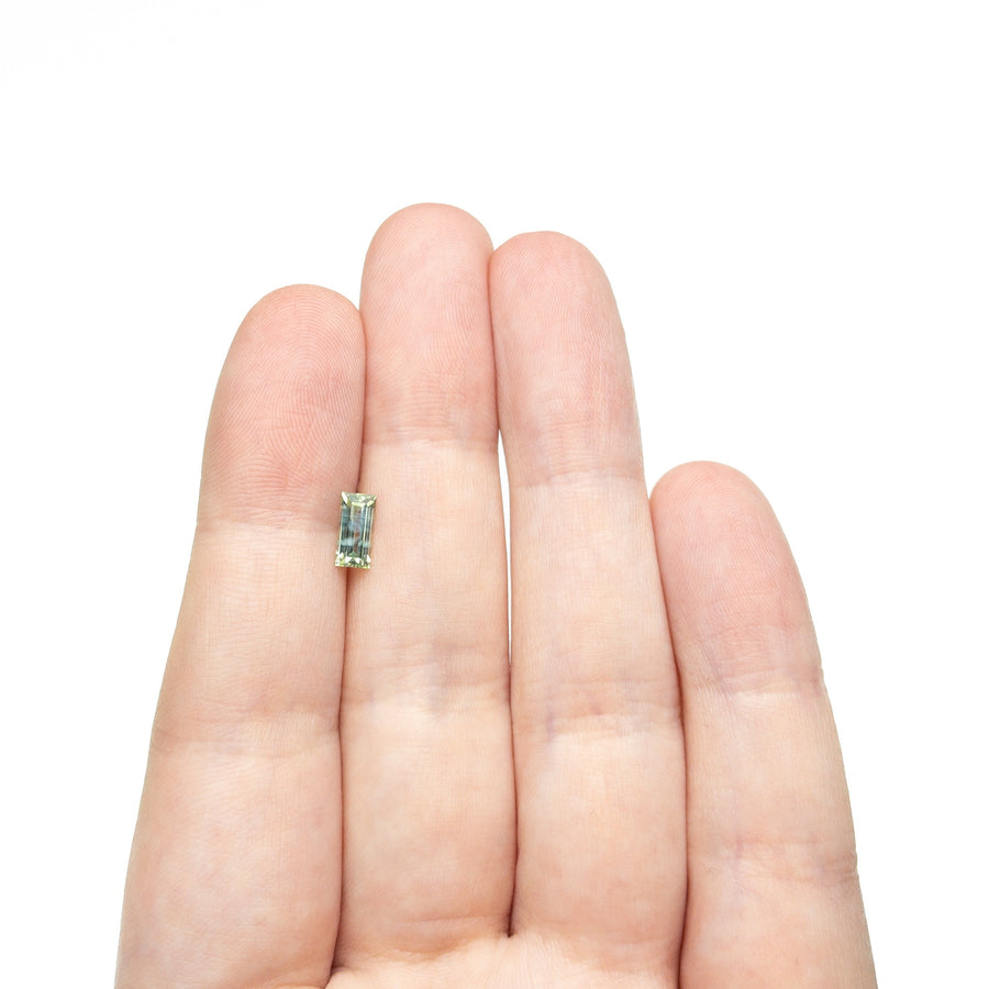 The 0.76ct 7.33x3.57x2.54mm Rectangle Step Cut Sapphire 27336-45 by East London jeweller Rachel Boston | Discover our collections of unique and timeless engagement rings, wedding rings, and modern fine jewellery. - Rachel Boston Jewellery
