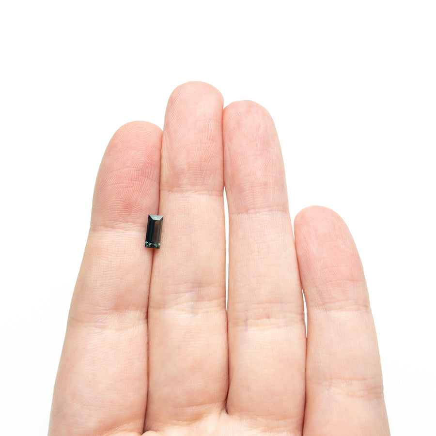 The 0.71ct 7.14x3.43x2.45mm Rectangle Step Cut Sapphire 27336-46 by East London jeweller Rachel Boston | Discover our collections of unique and timeless engagement rings, wedding rings, and modern fine jewellery. - Rachel Boston Jewellery