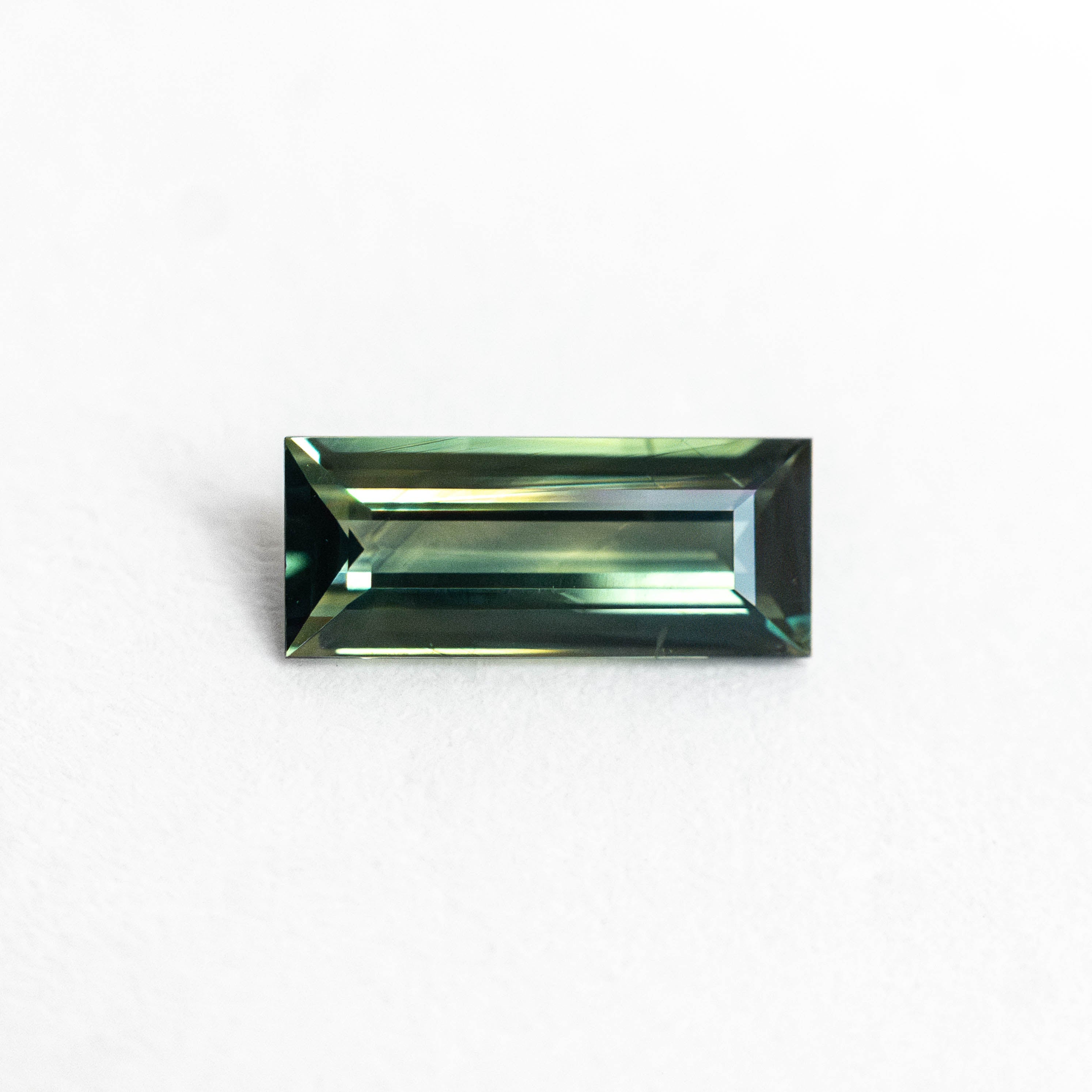 The 0.53ct 7.33x3.241.89mm Rectangle Step Cut Sapphire 27336-48 by East London jeweller Rachel Boston | Discover our collections of unique and timeless engagement rings, wedding rings, and modern fine jewellery.