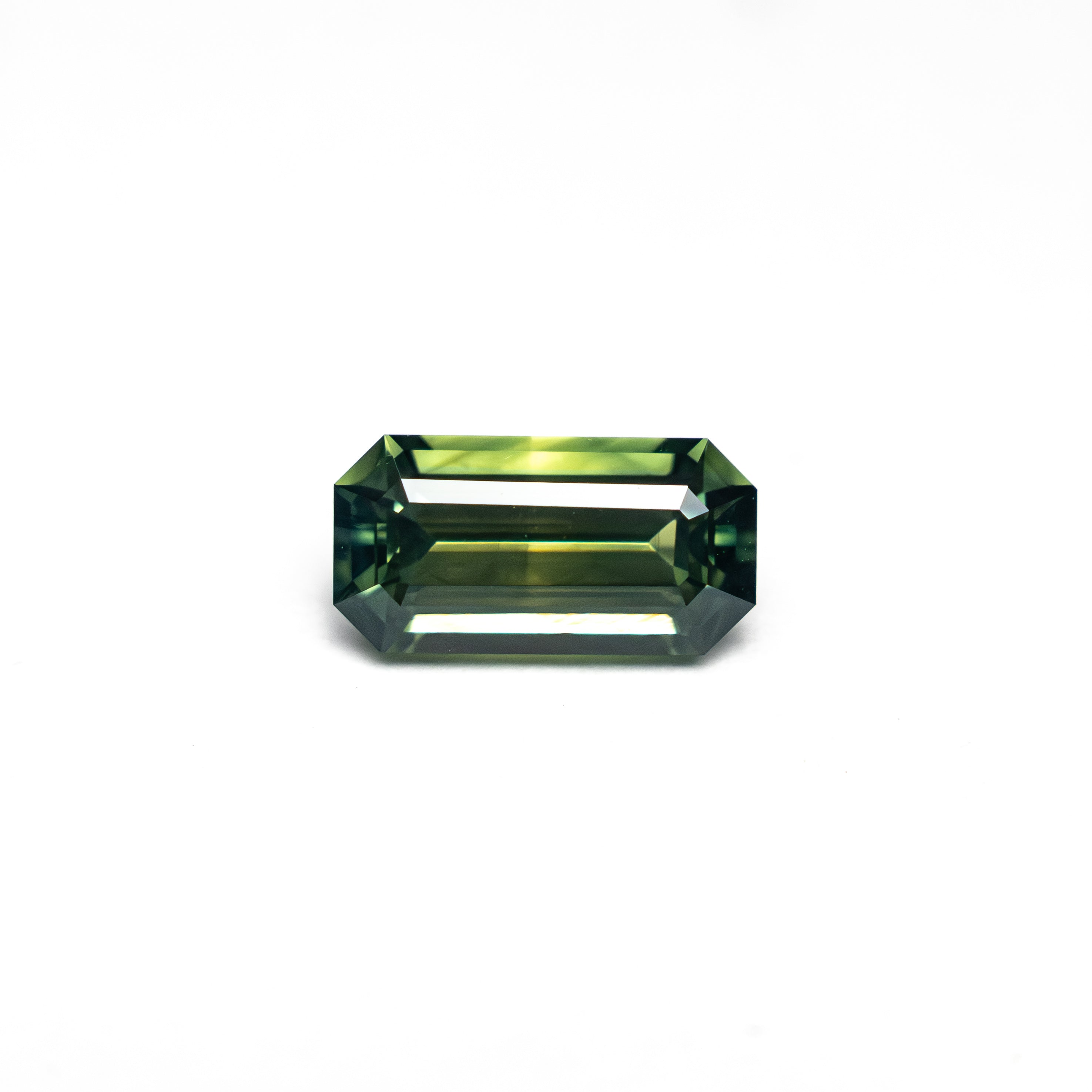 The 0.82ct 7.20x3.73x2.98mm Cut Corner Rectangle Step Cut Sapphire 27336-49 by East London jeweller Rachel Boston | Discover our collections of unique and timeless engagement rings, wedding rings, and modern fine jewellery.