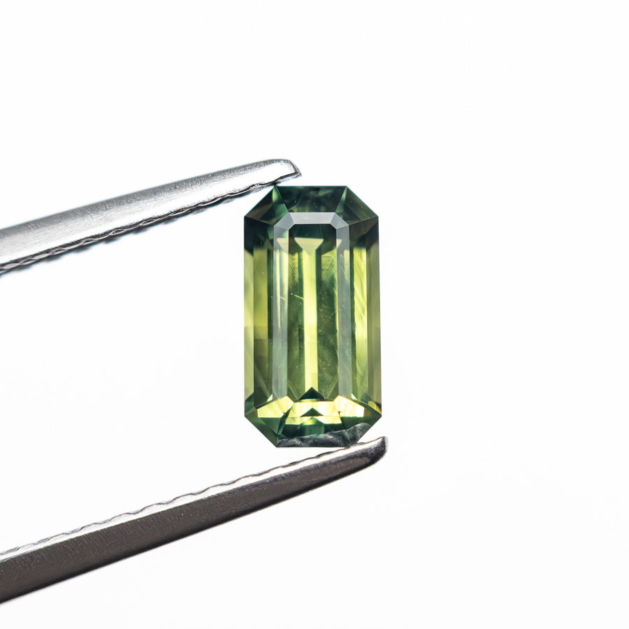 The 0.82ct 7.20x3.73x2.98mm Cut Corner Rectangle Step Cut Sapphire 27336-49 by East London jeweller Rachel Boston | Discover our collections of unique and timeless engagement rings, wedding rings, and modern fine jewellery. - Rachel Boston Jewellery