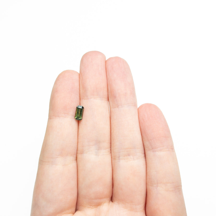 The 0.82ct 7.20x3.73x2.98mm Cut Corner Rectangle Step Cut Sapphire 27336-49 by East London jeweller Rachel Boston | Discover our collections of unique and timeless engagement rings, wedding rings, and modern fine jewellery. - Rachel Boston Jewellery