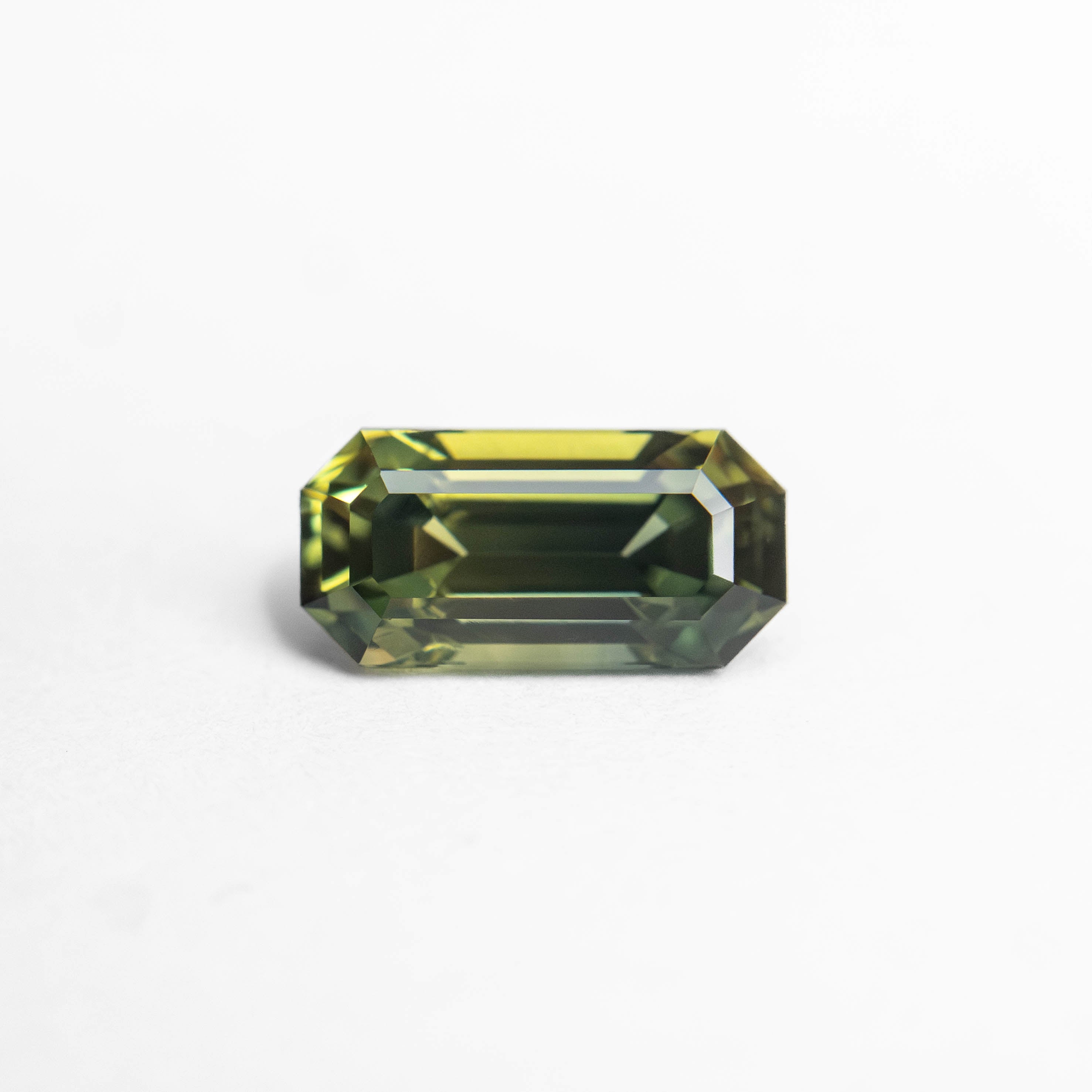 The 0.82ct 7.16x3.54x3.21mm Cut Corner Rectangle Step Cut Sapphire 27336-51 by East London jeweller Rachel Boston | Discover our collections of unique and timeless engagement rings, wedding rings, and modern fine jewellery.