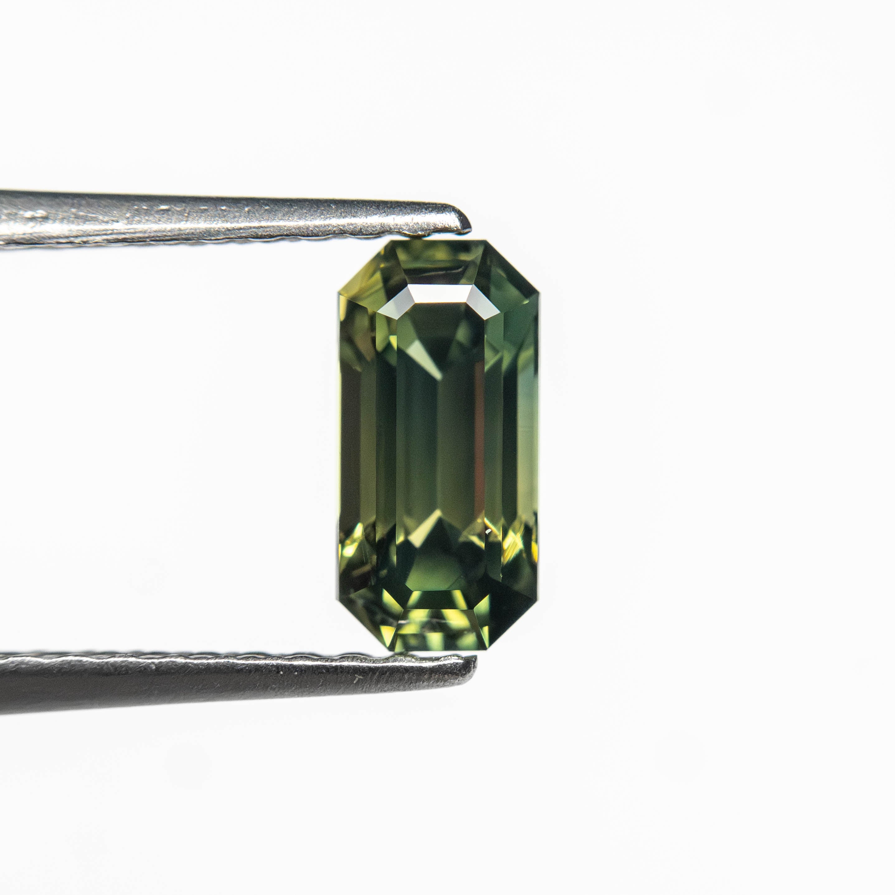 The 0.82ct 7.16x3.54x3.21mm Cut Corner Rectangle Step Cut Sapphire 27336-51 by East London jeweller Rachel Boston | Discover our collections of unique and timeless engagement rings, wedding rings, and modern fine jewellery.