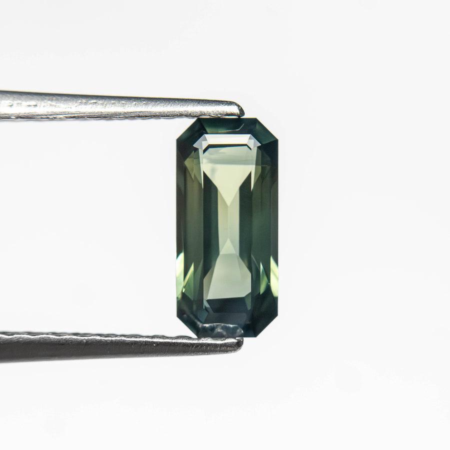 The 0.71ct 7.78x3.64x2.46mm Cut Corner Rectangle Step Cut Sapphire 27336-53 by East London jeweller Rachel Boston | Discover our collections of unique and timeless engagement rings, wedding rings, and modern fine jewellery. - Rachel Boston Jewellery