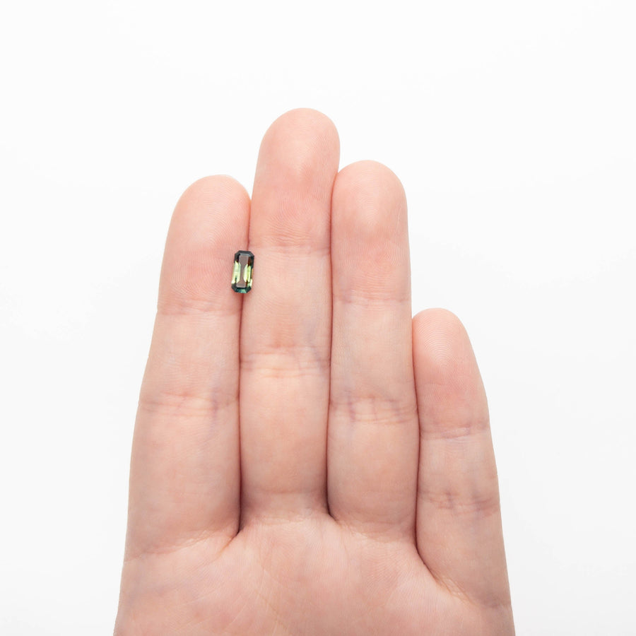 The 0.71ct 7.78x3.64x2.46mm Cut Corner Rectangle Step Cut Sapphire 27336-53 by East London jeweller Rachel Boston | Discover our collections of unique and timeless engagement rings, wedding rings, and modern fine jewellery. - Rachel Boston Jewellery