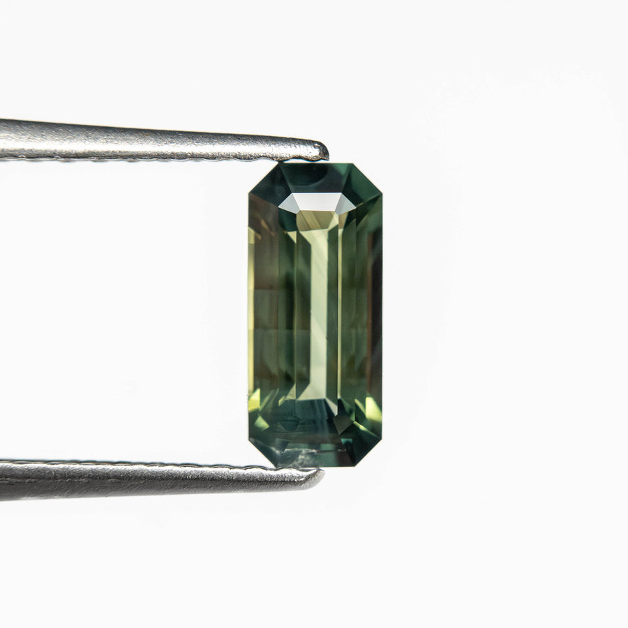 The 0.78ct 8.00x3.57x2.63mm Cut Corner Rectangle Step Cut Sapphire 27336-56 by East London jeweller Rachel Boston | Discover our collections of unique and timeless engagement rings, wedding rings, and modern fine jewellery. - Rachel Boston Jewellery