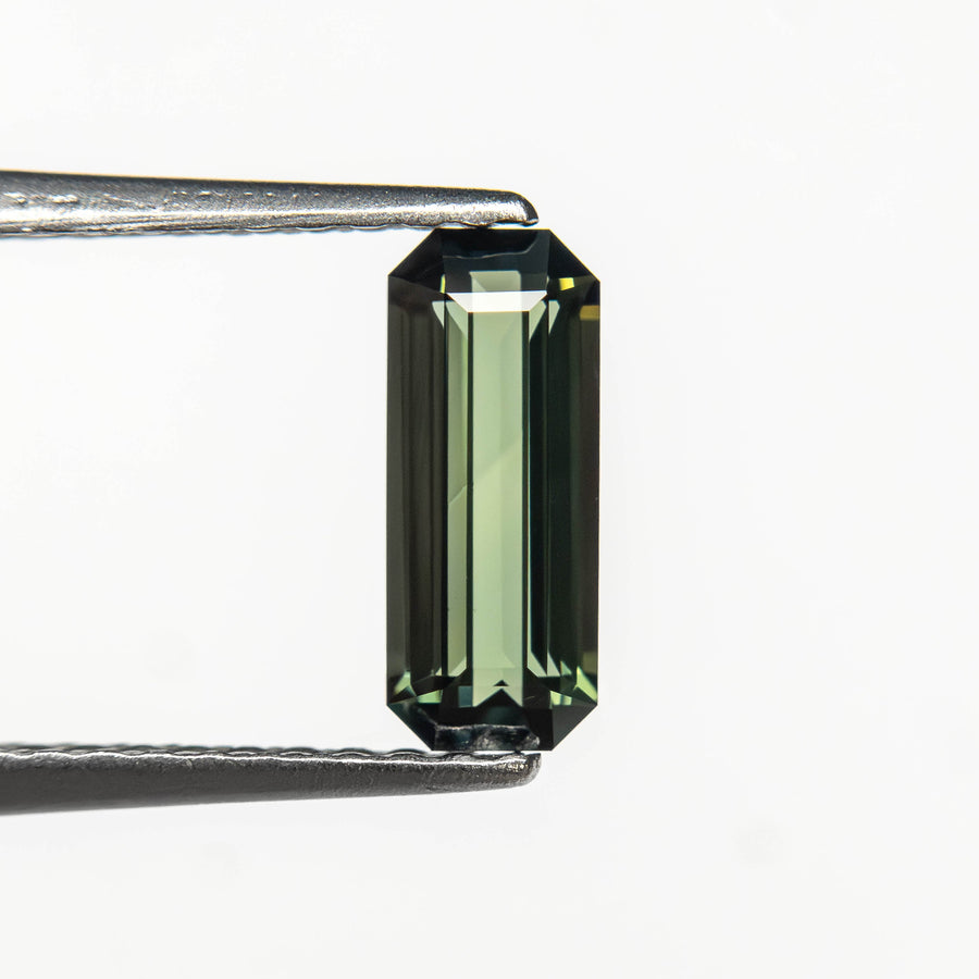 The 0.77ct 8.35x3.41x2.50mm Cut Corner Rectangle Step Cut Sapphire 27336-58 by East London jeweller Rachel Boston | Discover our collections of unique and timeless engagement rings, wedding rings, and modern fine jewellery. - Rachel Boston Jewellery