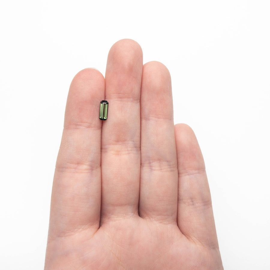 The 0.77ct 8.35x3.41x2.50mm Cut Corner Rectangle Step Cut Sapphire 27336-58 by East London jeweller Rachel Boston | Discover our collections of unique and timeless engagement rings, wedding rings, and modern fine jewellery. - Rachel Boston Jewellery