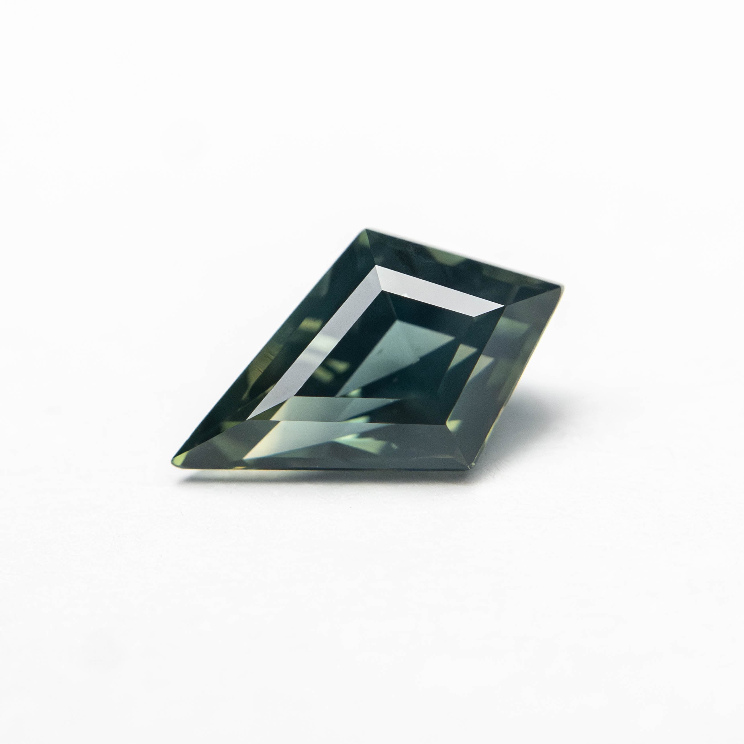 The 0.67ct 8.12x4.94x3.15mm Kite Step Cut Sapphire 27363-15 by East London jeweller Rachel Boston | Discover our collections of unique and timeless engagement rings, wedding rings, and modern fine jewellery.