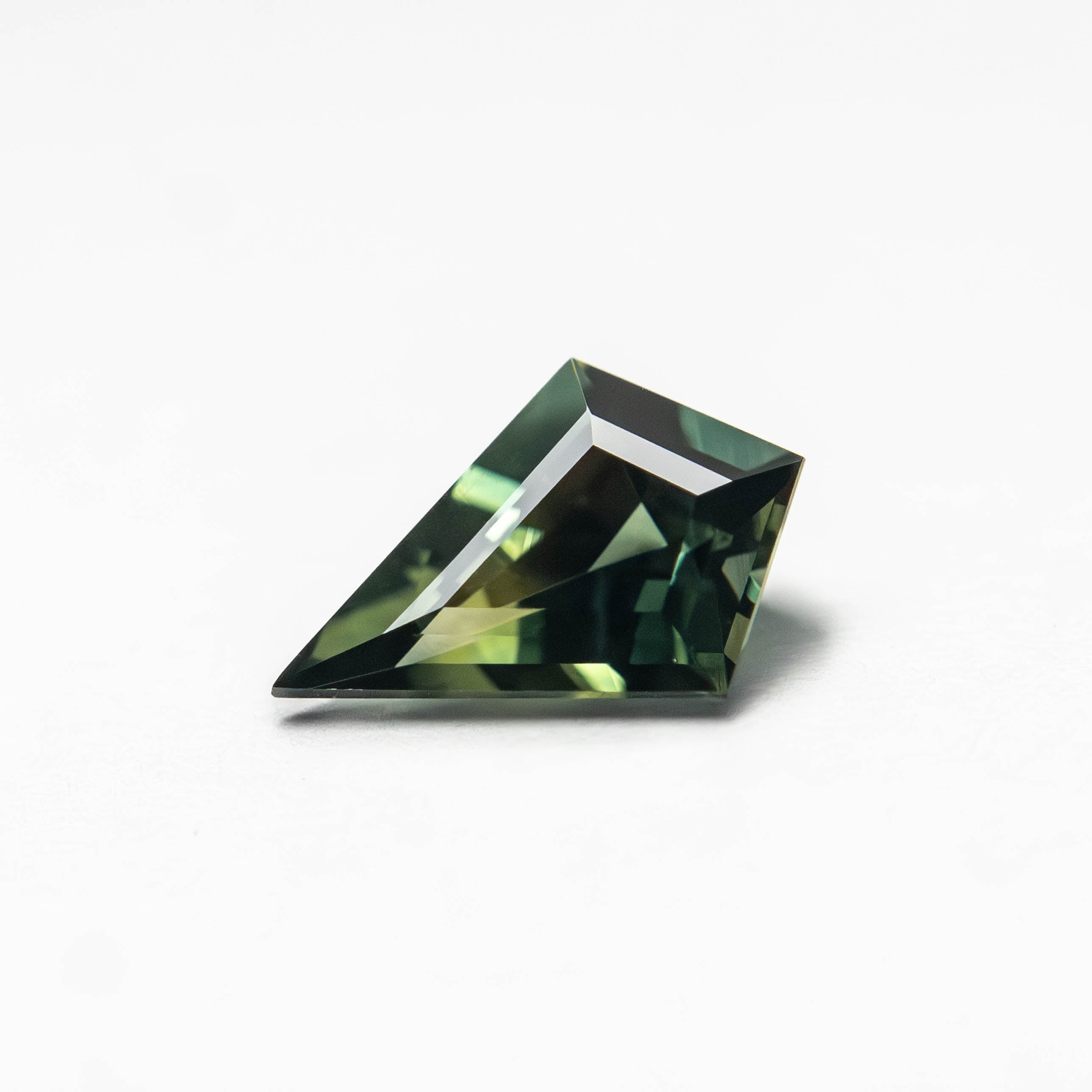 The 0.50ct 7.34x4.96x2.87mm Kite Step Cut Sapphire 27363-16 by East London jeweller Rachel Boston | Discover our collections of unique and timeless engagement rings, wedding rings, and modern fine jewellery.