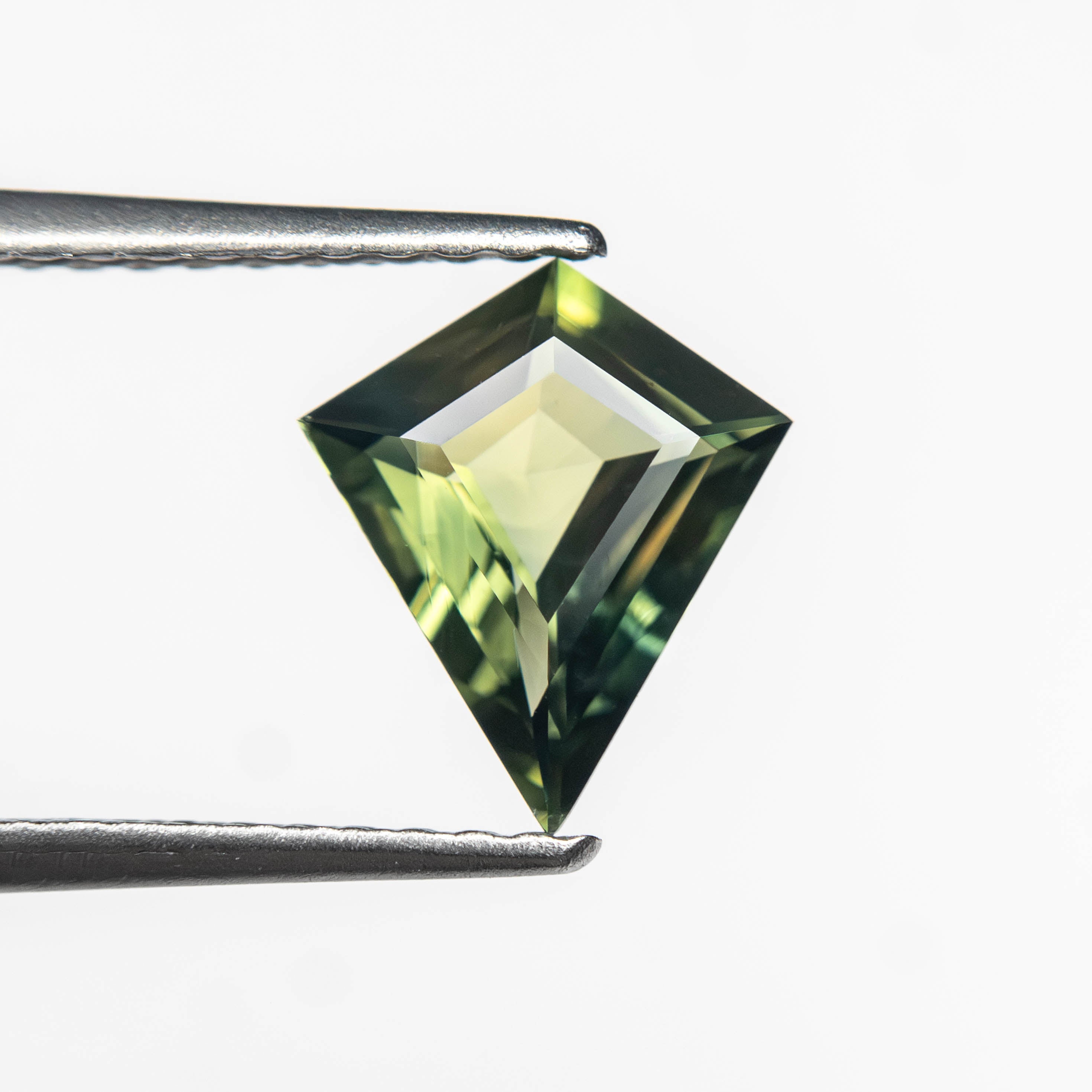 The 0.85ct 8.47x7.22x2.84mm Kite Step Cut Sapphire 27363-19 by East London jeweller Rachel Boston | Discover our collections of unique and timeless engagement rings, wedding rings, and modern fine jewellery.