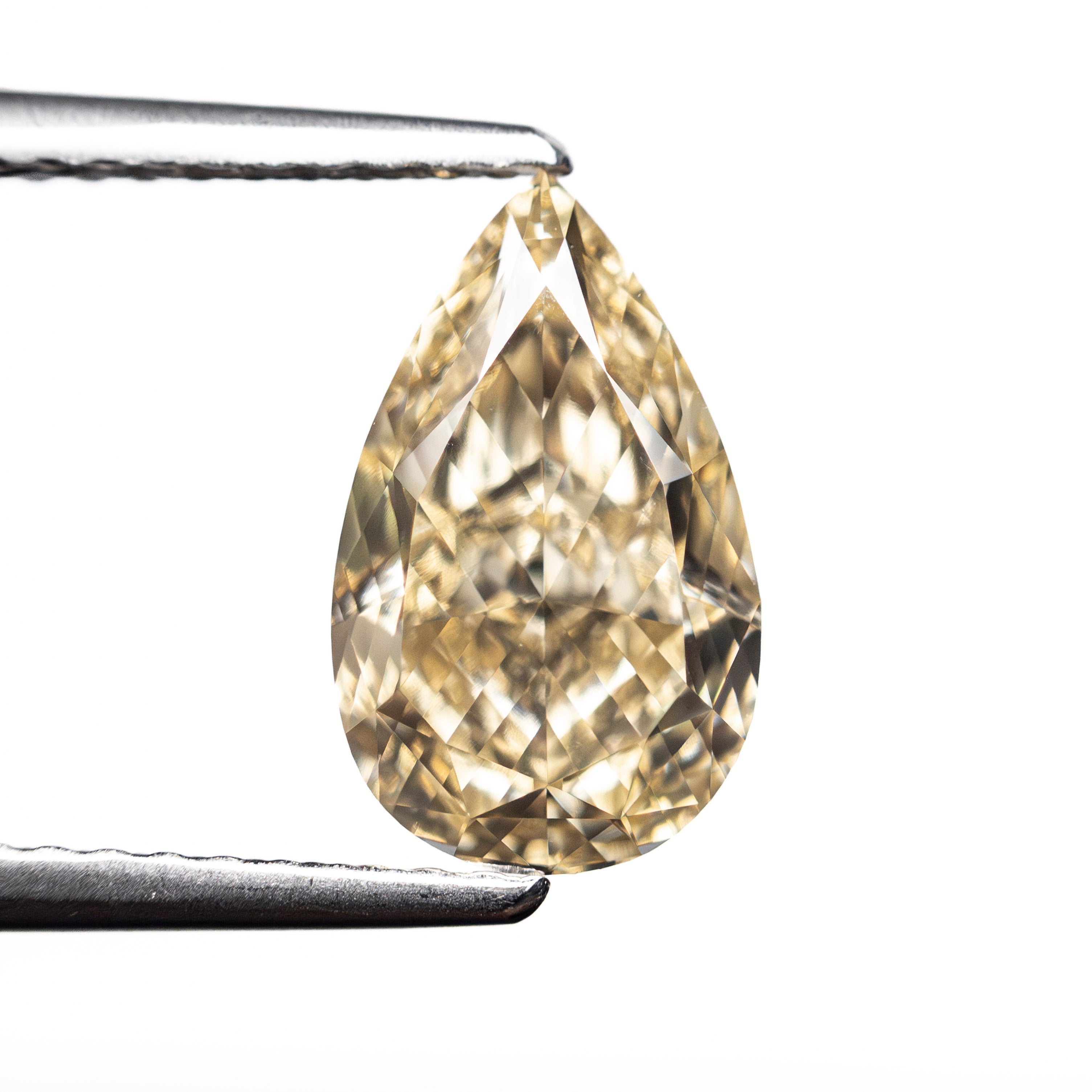The 2.23ct 10.76x6.50x4.33mm GIA VVS2 Fancy Brownish Yellow Pear Brilliant 🇨🇦 27709-01 by East London jeweller Rachel Boston | Discover our collections of unique and timeless engagement rings, wedding rings, and modern fine jewellery.