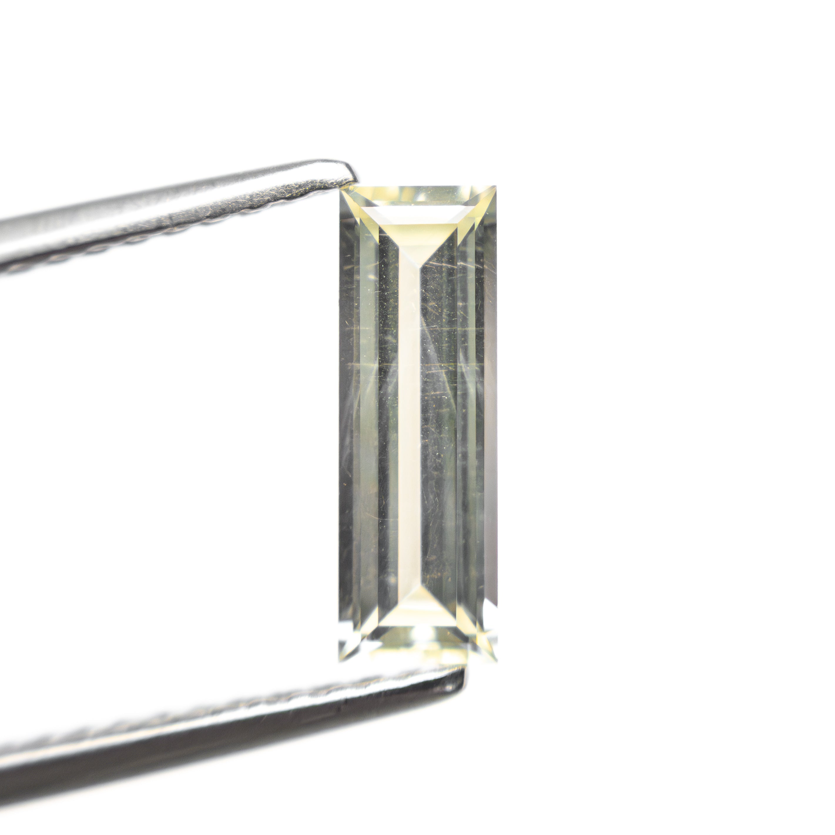 The 0.84ct 9.95x3.36x2.17mm Baguette Step Cut Sapphire 27719-01 by East London jeweller Rachel Boston | Discover our collections of unique and timeless engagement rings, wedding rings, and modern fine jewellery.