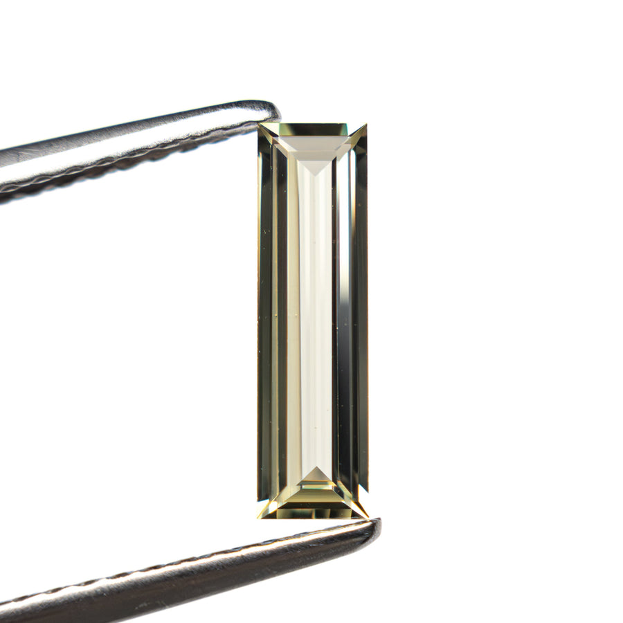 The 0.62ct 10.53x2.95x1.70mm Baguette Step Cut Sapphire 27719-04 by East London jeweller Rachel Boston | Discover our collections of unique and timeless engagement rings, wedding rings, and modern fine jewellery. - Rachel Boston Jewellery