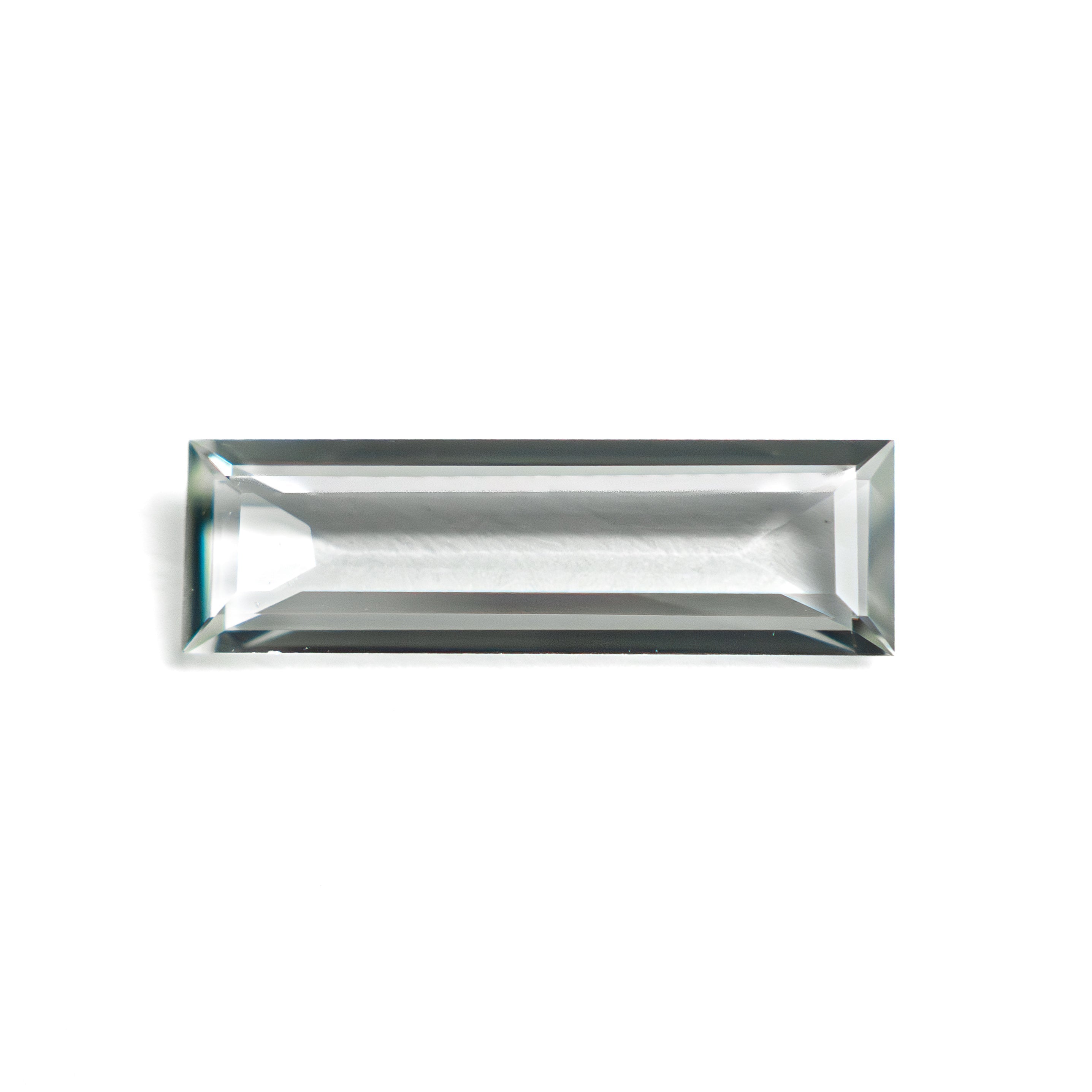 The 0.81ct 11.41x3.48x1.63mm Baguette Step Cut Sapphire 27720-05 by East London jeweller Rachel Boston | Discover our collections of unique and timeless engagement rings, wedding rings, and modern fine jewellery.