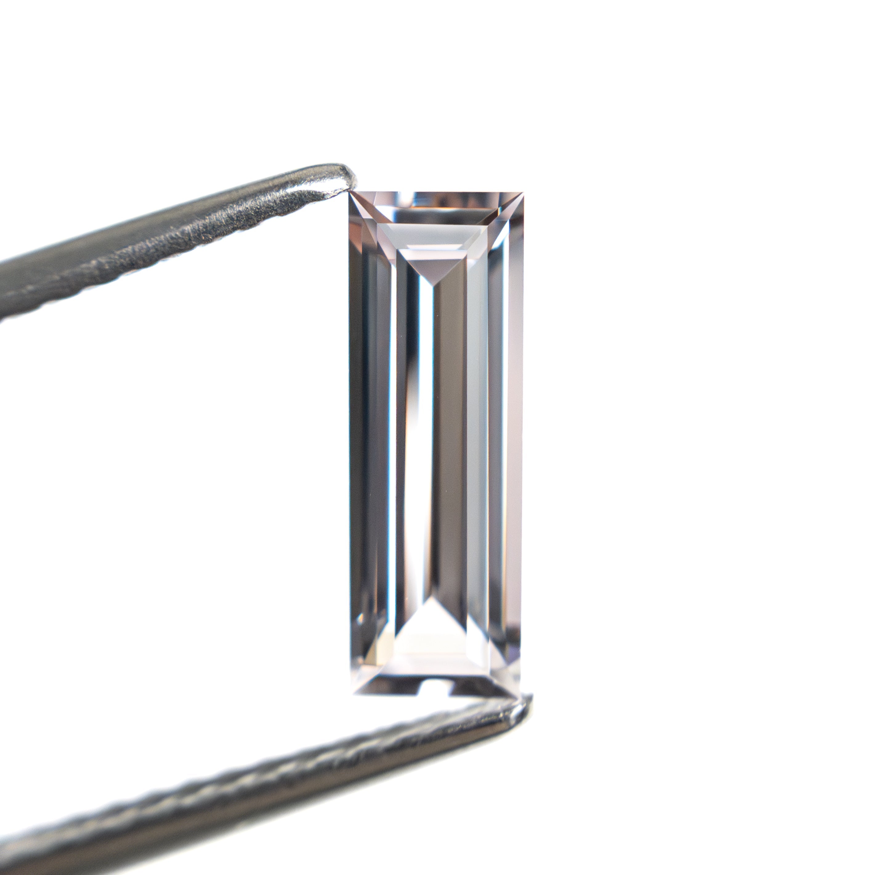 The 0.91ct 10.30x3.53x2.27mm Baguette Step Cut Sapphire 27720-06 by East London jeweller Rachel Boston | Discover our collections of unique and timeless engagement rings, wedding rings, and modern fine jewellery.