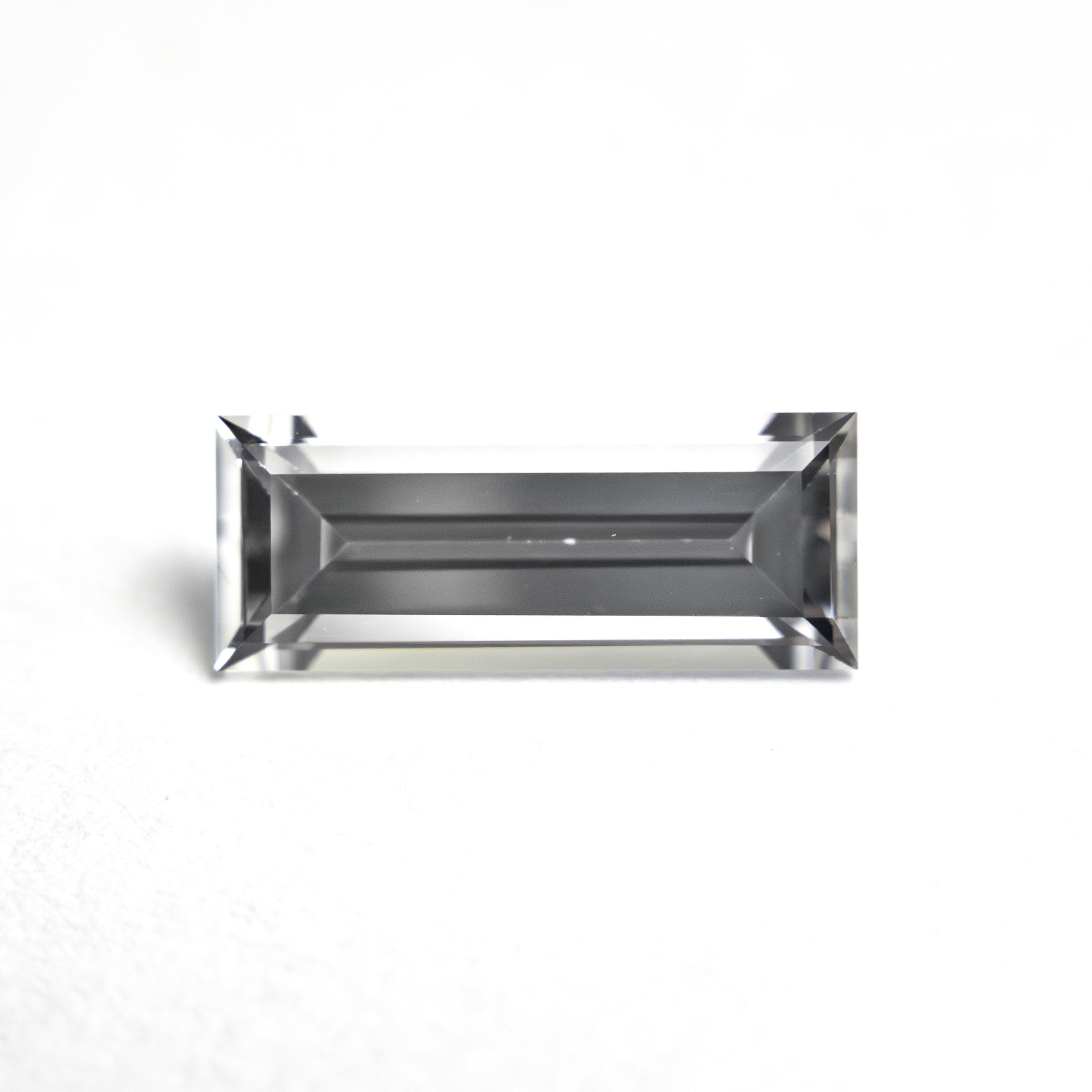 The 1.06ct 9.53x3.81x2.64mm Baguette Step Cut Sapphire 27720-07 by East London jeweller Rachel Boston | Discover our collections of unique and timeless engagement rings, wedding rings, and modern fine jewellery.
