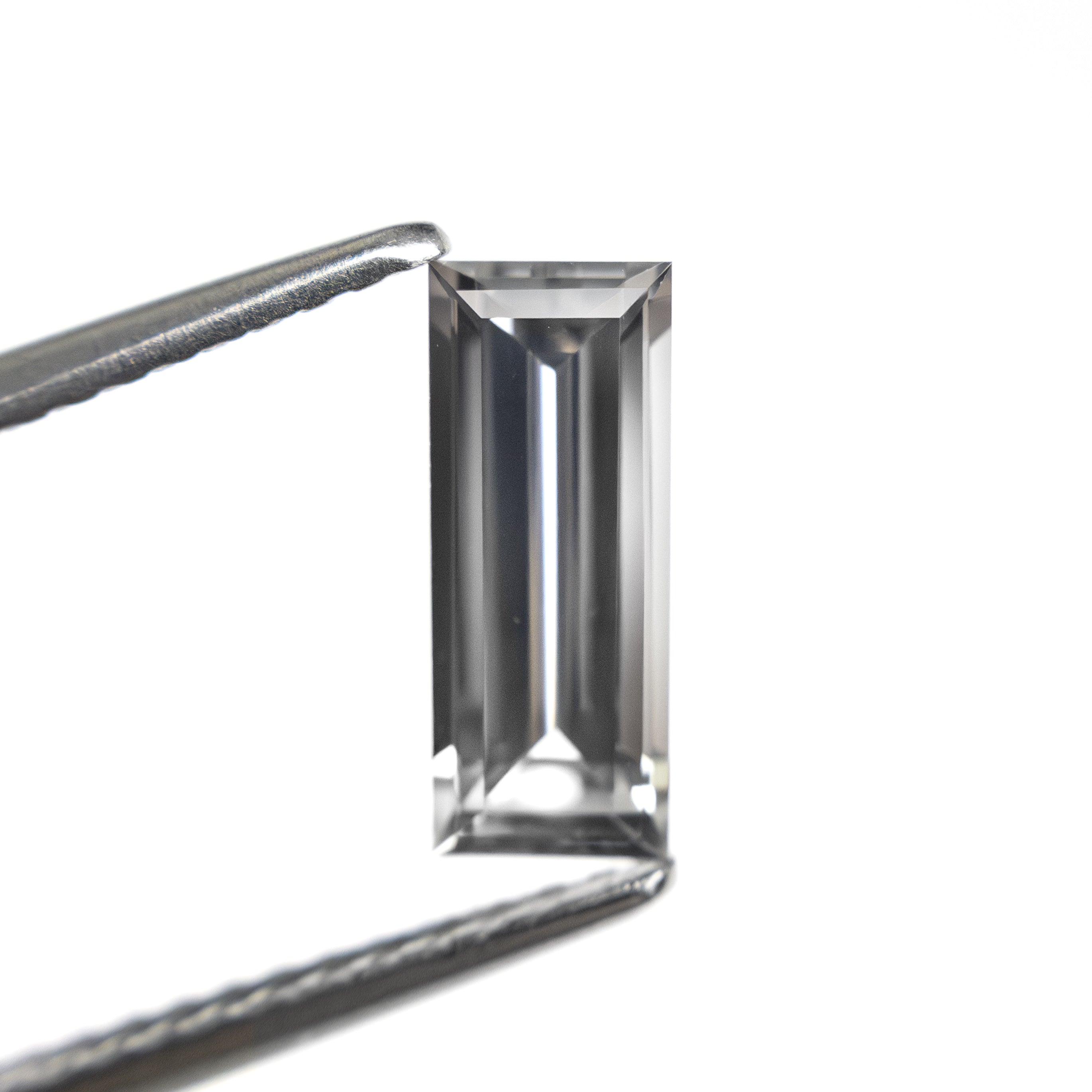 The 1.06ct 9.53x3.81x2.64mm Baguette Step Cut Sapphire 27720-07 by East London jeweller Rachel Boston | Discover our collections of unique and timeless engagement rings, wedding rings, and modern fine jewellery.