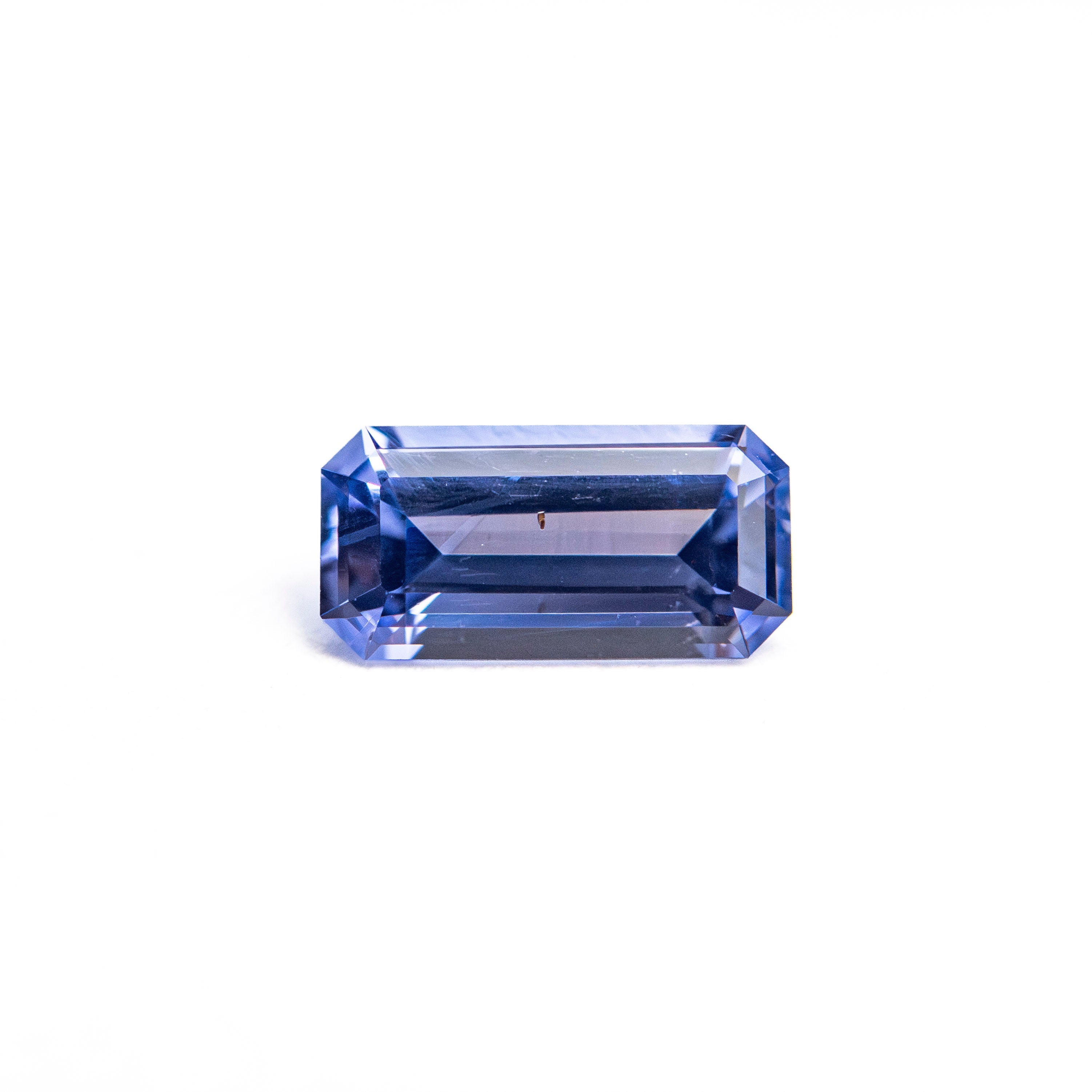 The 0.62ct 6.96x3.49x2.46mm Cut Corner Rectangle Step Cut Sapphire 27721-03 by East London jeweller Rachel Boston | Discover our collections of unique and timeless engagement rings, wedding rings, and modern fine jewellery.
