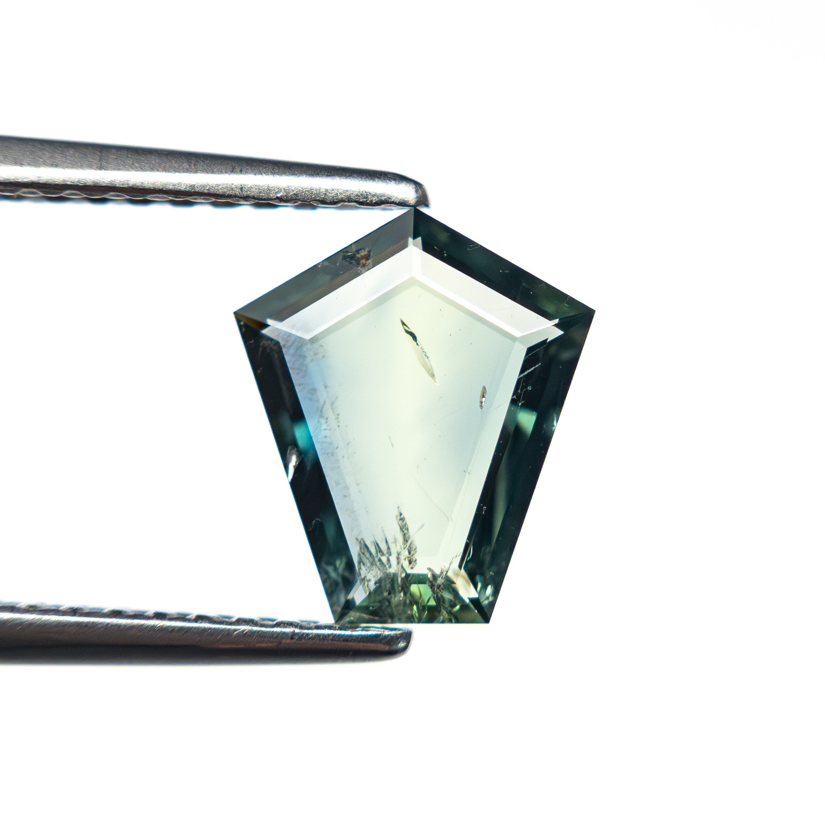 The 1.04ct 8.63x7.51x1.66mm Shield Portrait Cut Sapphire 27730-04 by East London jeweller Rachel Boston | Discover our collections of unique and timeless engagement rings, wedding rings, and modern fine jewellery.