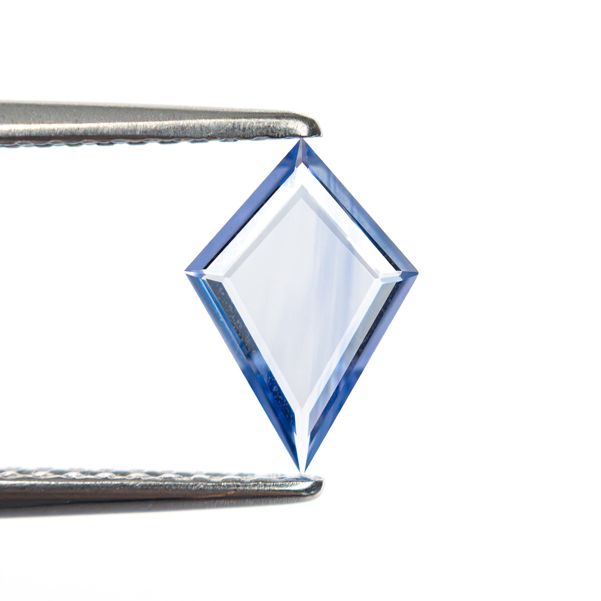 The 0.61ct 9.49x6.57x1.31mm Kite Portrait Cut Sapphire 27740-07 by East London jeweller Rachel Boston | Discover our collections of unique and timeless engagement rings, wedding rings, and modern fine jewellery.