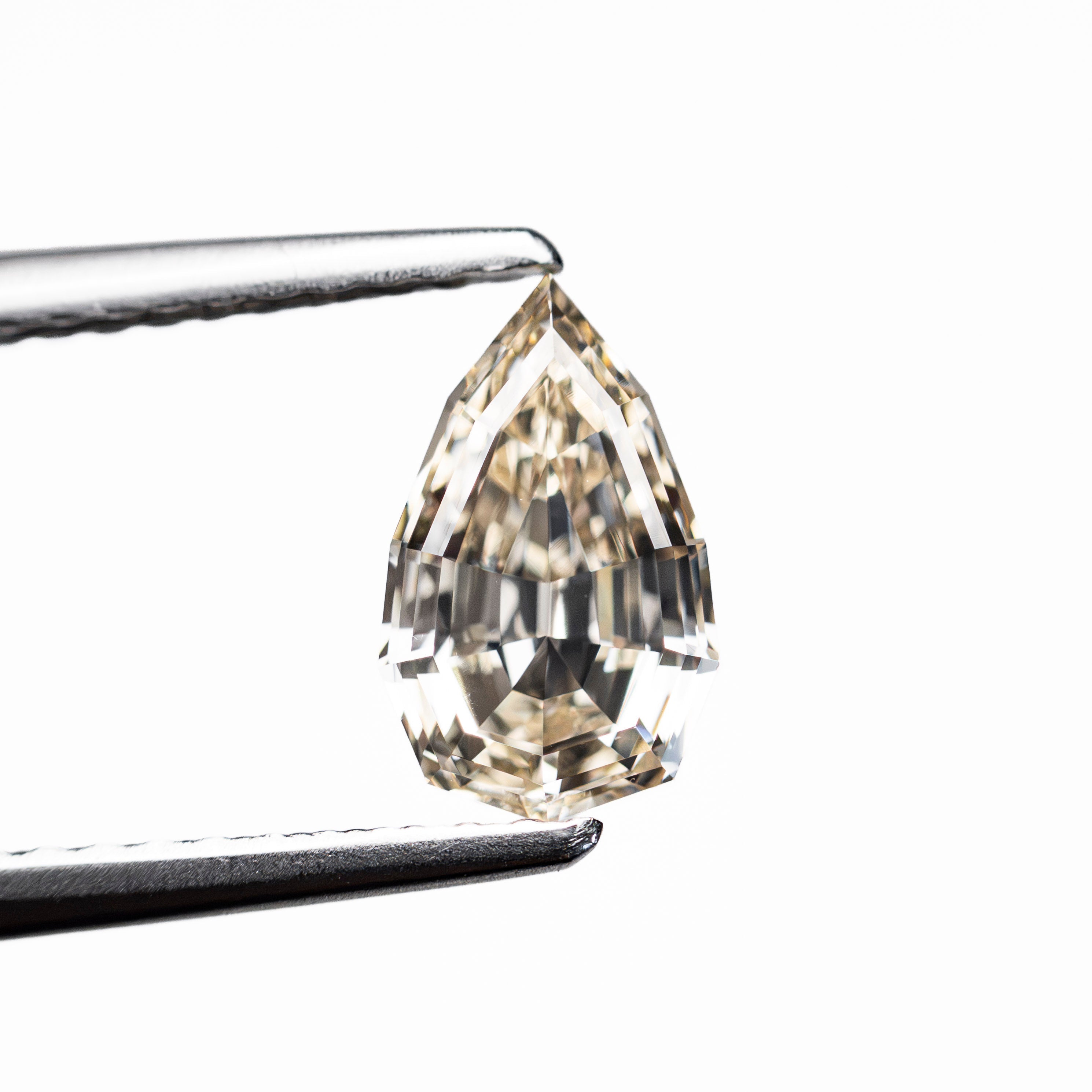 The 1.06ct 8.52x5.22x3.28mm VVS2 W-X Geo Pear Step Cut 28054-01 by East London jeweller Rachel Boston | Discover our collections of unique and timeless engagement rings, wedding rings, and modern fine jewellery.