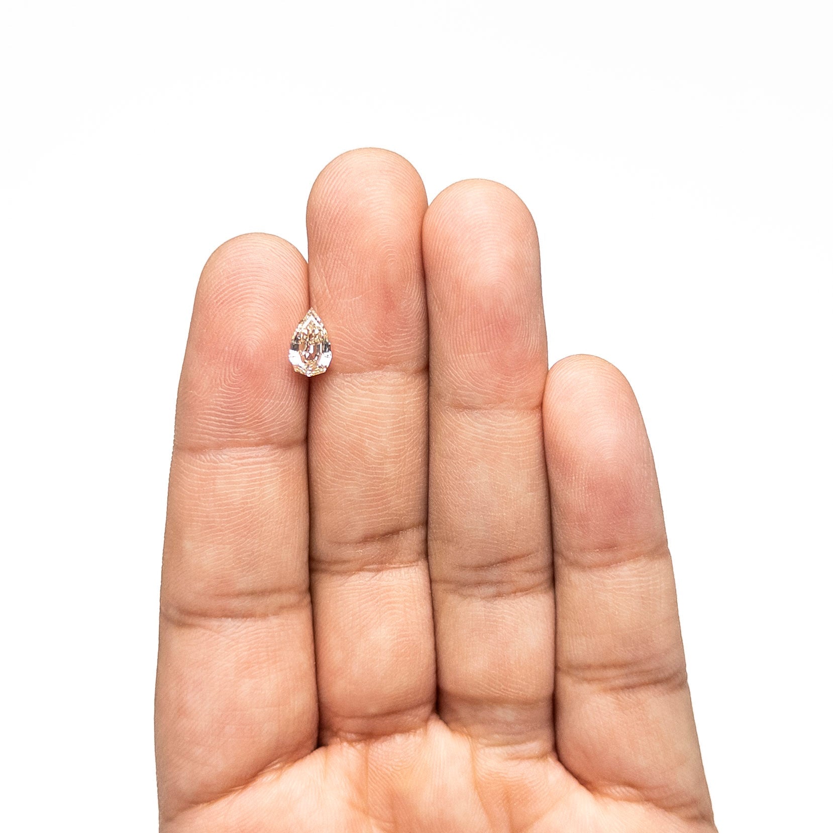 The 1.06ct 8.52x5.22x3.28mm VVS2 W-X Geo Pear Step Cut 28054-01 by East London jeweller Rachel Boston | Discover our collections of unique and timeless engagement rings, wedding rings, and modern fine jewellery.