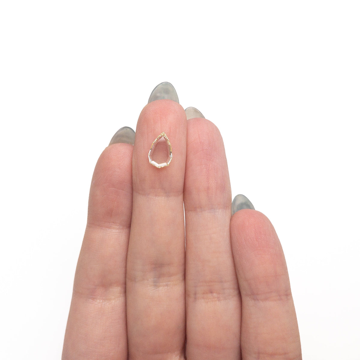 The 1.27ct 10.22x6.81x1.99mm GIA VS1 Q-R Geo Pear Portrait Cut 28329-01 by East London jeweller Rachel Boston | Discover our collections of unique and timeless engagement rings, wedding rings, and modern fine jewellery.